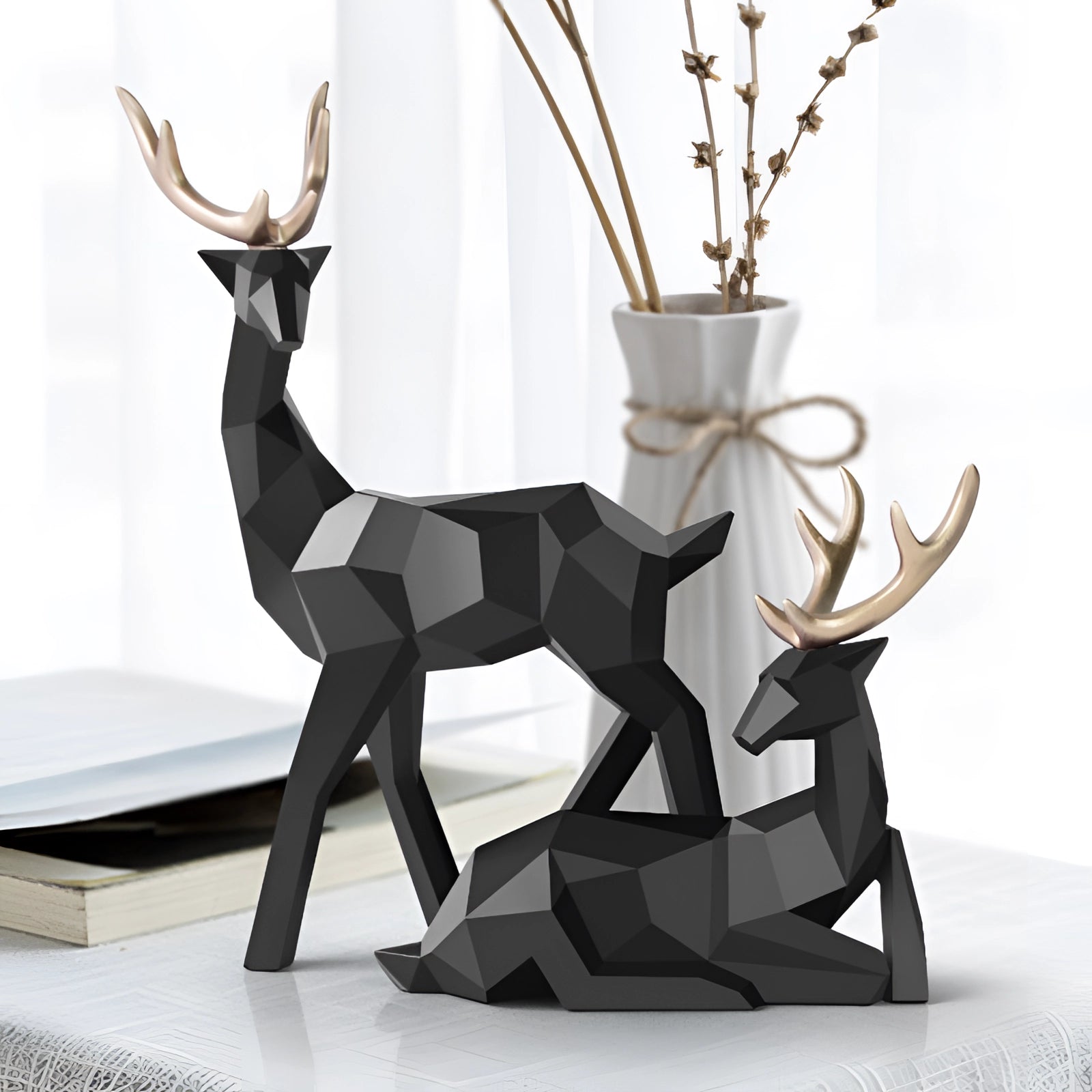 Black and white modern geometric deer sculpture with minimalist design, featuring abstract representation of a deer, made from natural materials, set against a plain background.