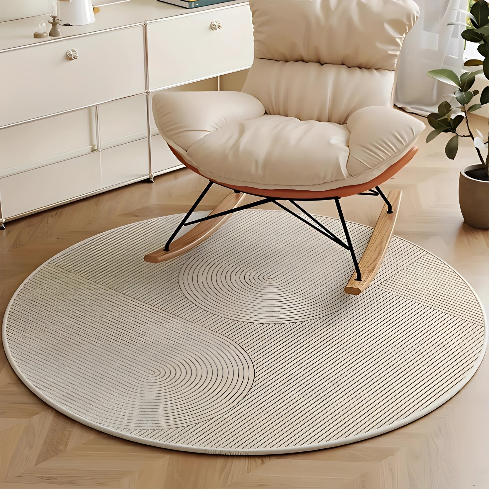 Modern geometric round rug in a living room setting with white and wood elements, surrounded by chairs and potted plants, enhancing the interior design and flooring with a touch of comfort.