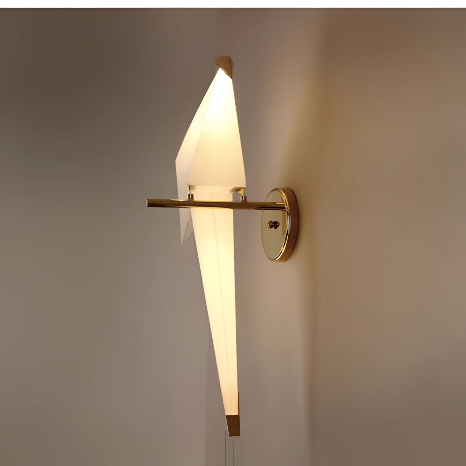 Modern geometric wall sconce with amber glow, featuring copper accents and a circular design, suitable for indoor lighting.