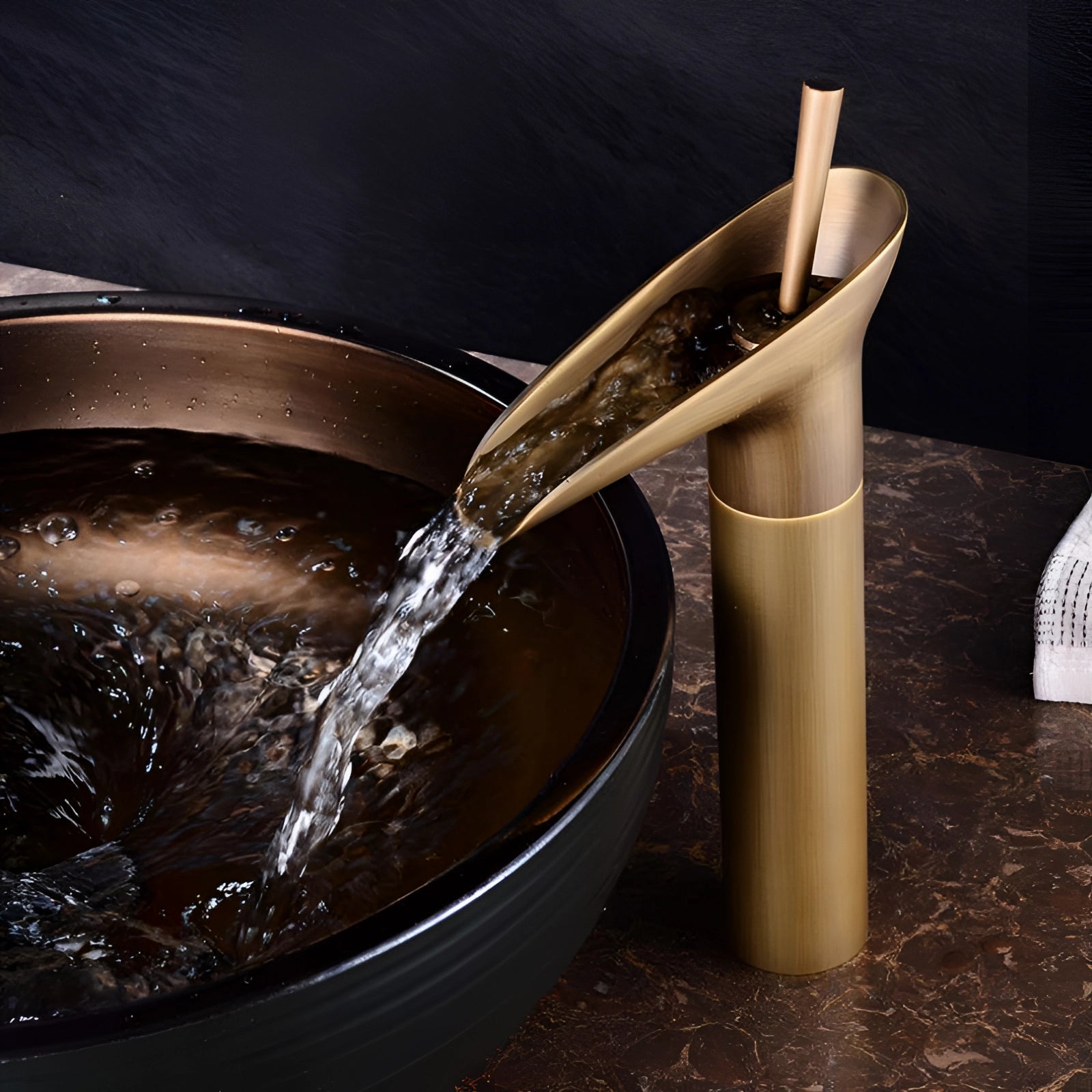 Antique Gold Modern Waterfall Faucet made of luxury brass, designed for a small vessel sink, with a sleek and elegant spout resembling a steady flow of liquid.