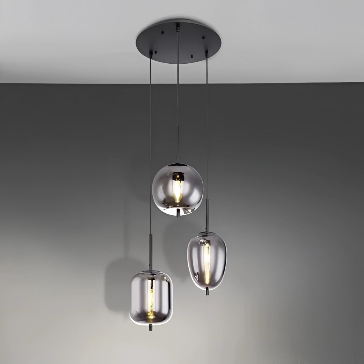 Modern Industrial Glass Pendant Lights with Bronze Finish hanging over a dining room table.