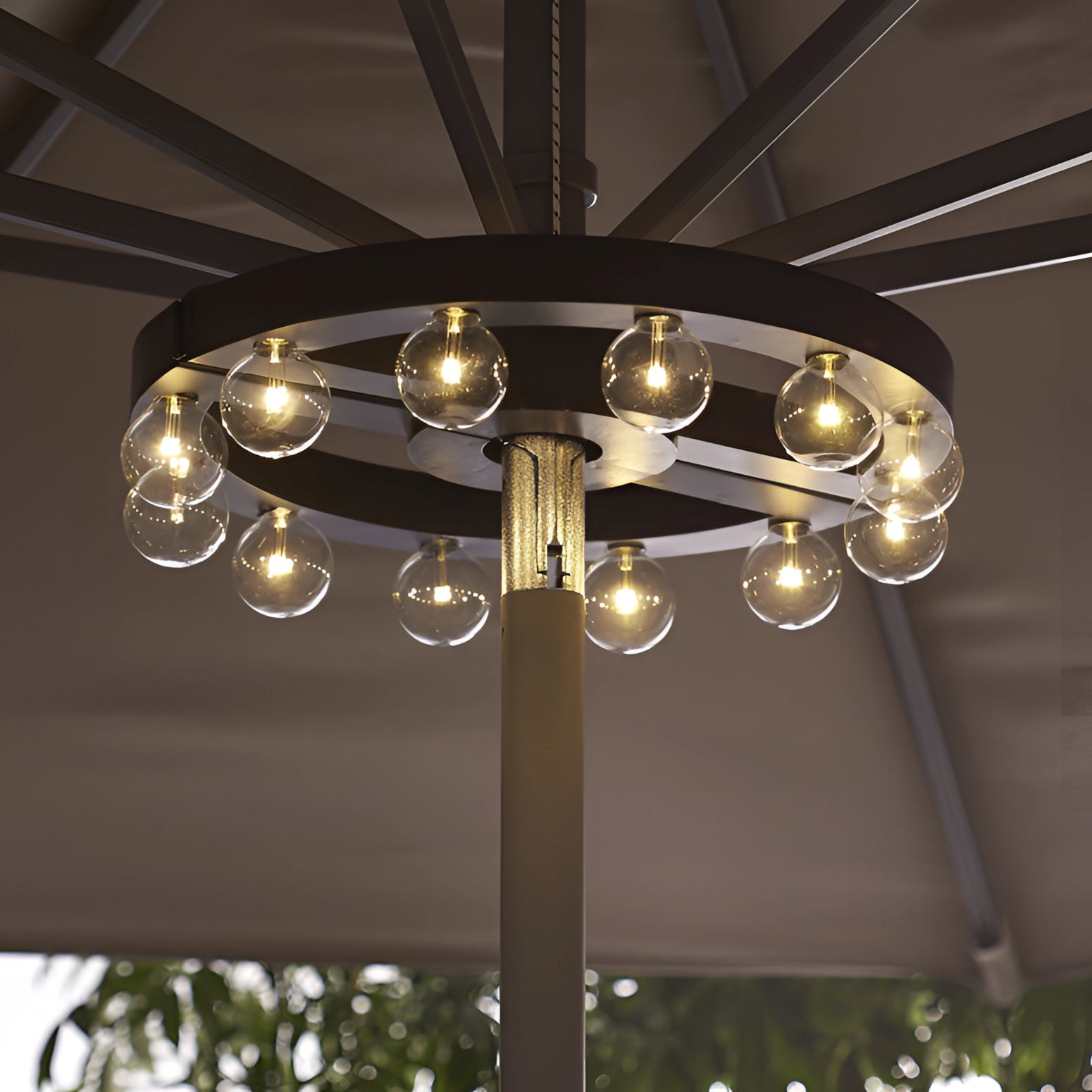 Modern industrial round chandelier with exposed filament bulbs, featuring a white finish and hanging from the ceiling, illuminating the space with warm lighting.