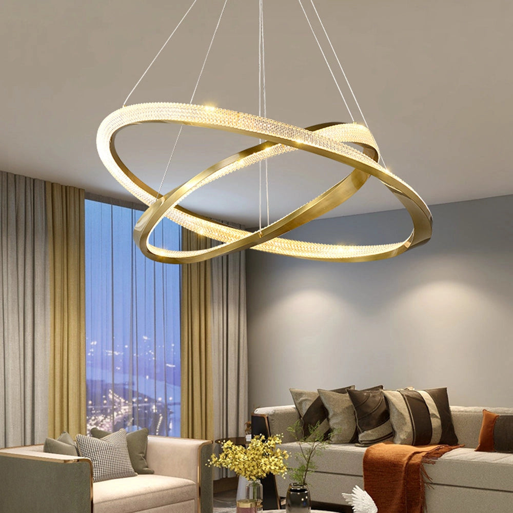 Modern LED chandelier with a golden minimalist pendant light design hanging in a stylishly decorated living room, featuring a comfortable couch and a wooden table, highlighting contemporary interior design elements.