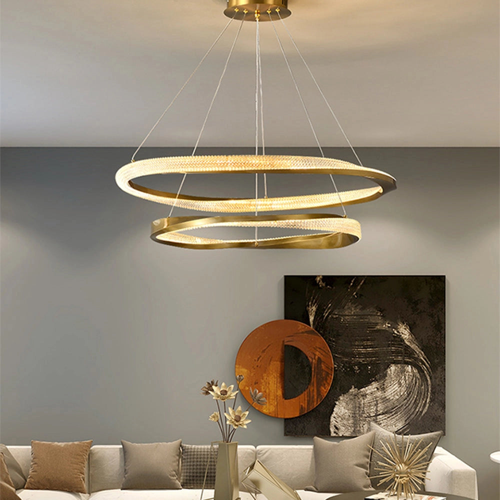 Modern LED chandelier with a golden minimalist pendant light design, featuring a linear arrangement and a warm yellow glow, set in a stylish interior with wooden accents and artistic wall elements.