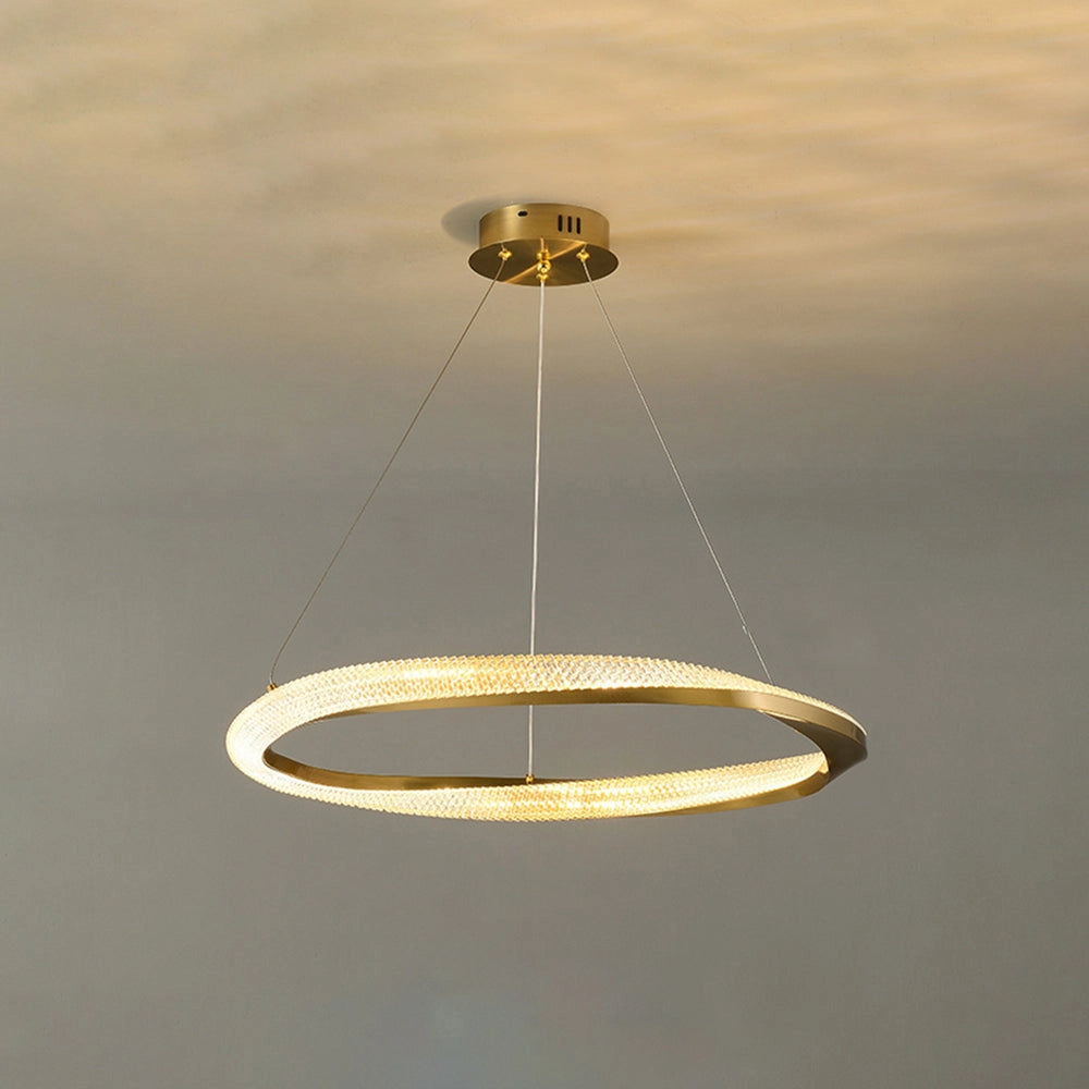 Modern LED chandelier with a golden minimalist pendant light design, featuring circular elements and sleek lines, against a background that resembles a softly lit sky.