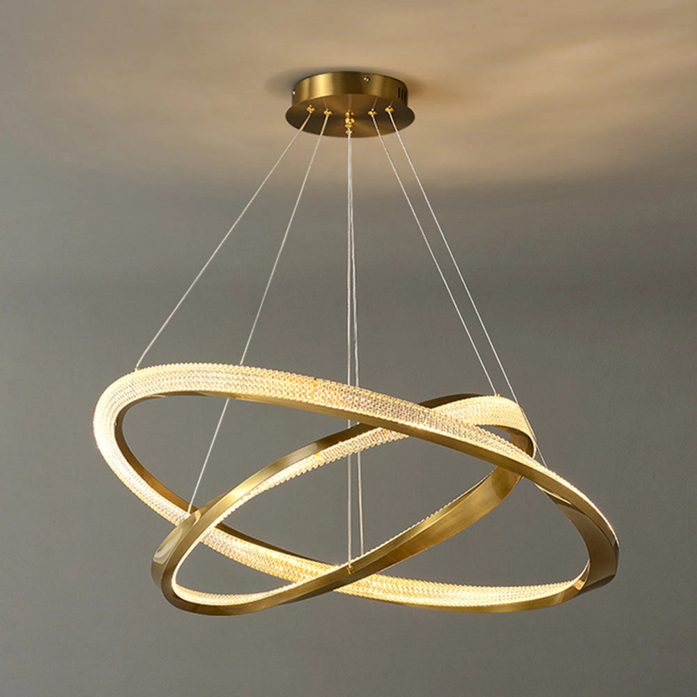 Modern LED chandelier with a golden minimalist pendant light design, featuring elegant circular elements and metallic accents, casting a warm amber hue.