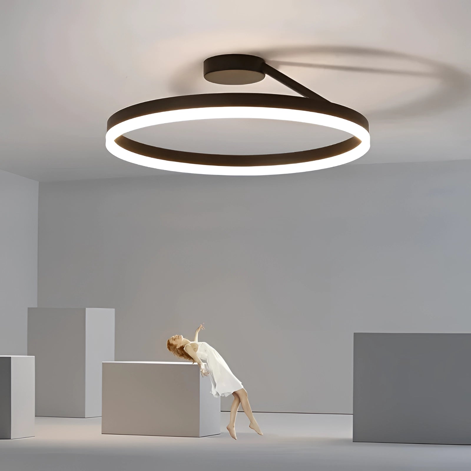 Modern LED circular ceiling light fixture with a sleek black design, shown in a dimmable down glow setting, elegantly integrated into a contemporary interior space with wooden elements.