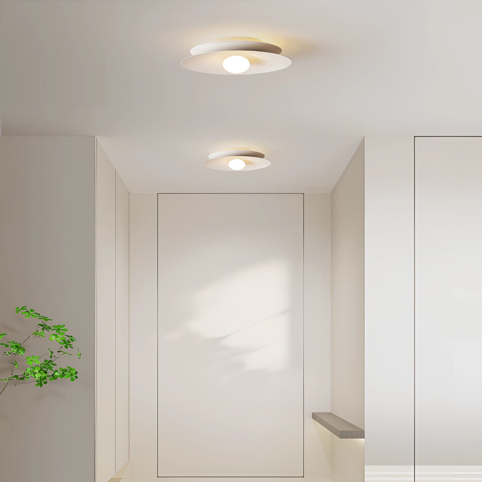 Modern LED disc ceiling light installed on a minimalist room ceiling.