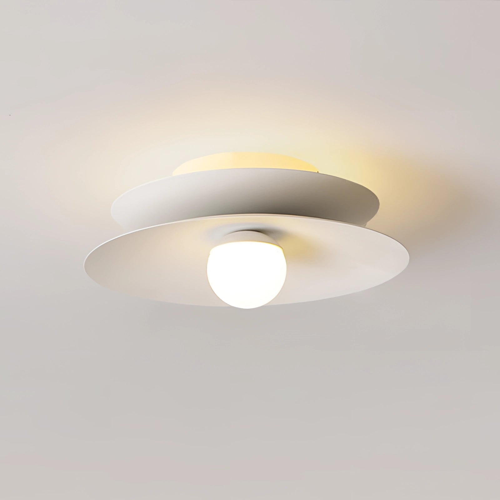 Modern LED disc ceiling light with a minimalist design, flush mounted to the ceiling. The round fixture features a sleek and simple appearance, suitable for contemporary interior design.