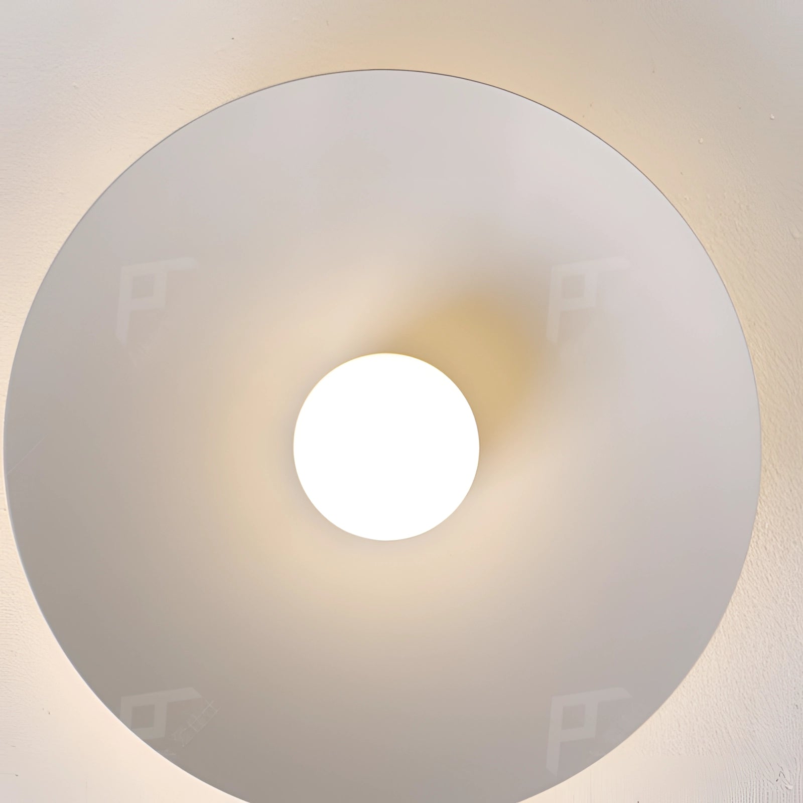 Modern LED disc ceiling light with a minimalist flush mount design, featuring a circular shape and sleek symmetry, installed on a ceiling as a lighting accessory.