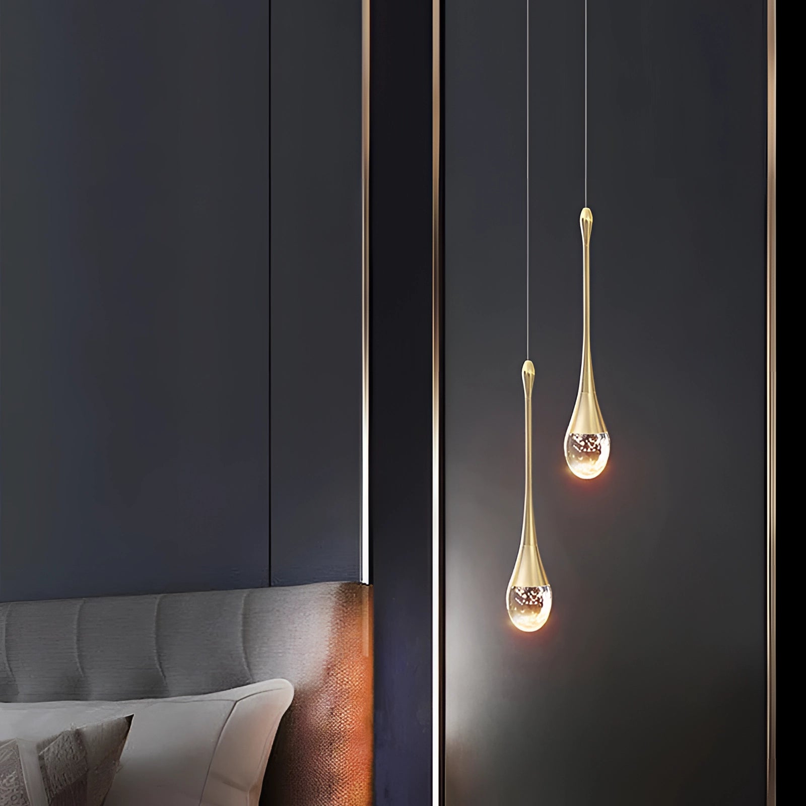 Modern LED gold teardrop pendant lights hanging from a ceiling, illuminating a kitchen or dining room setting with a warm and cozy ambiance.