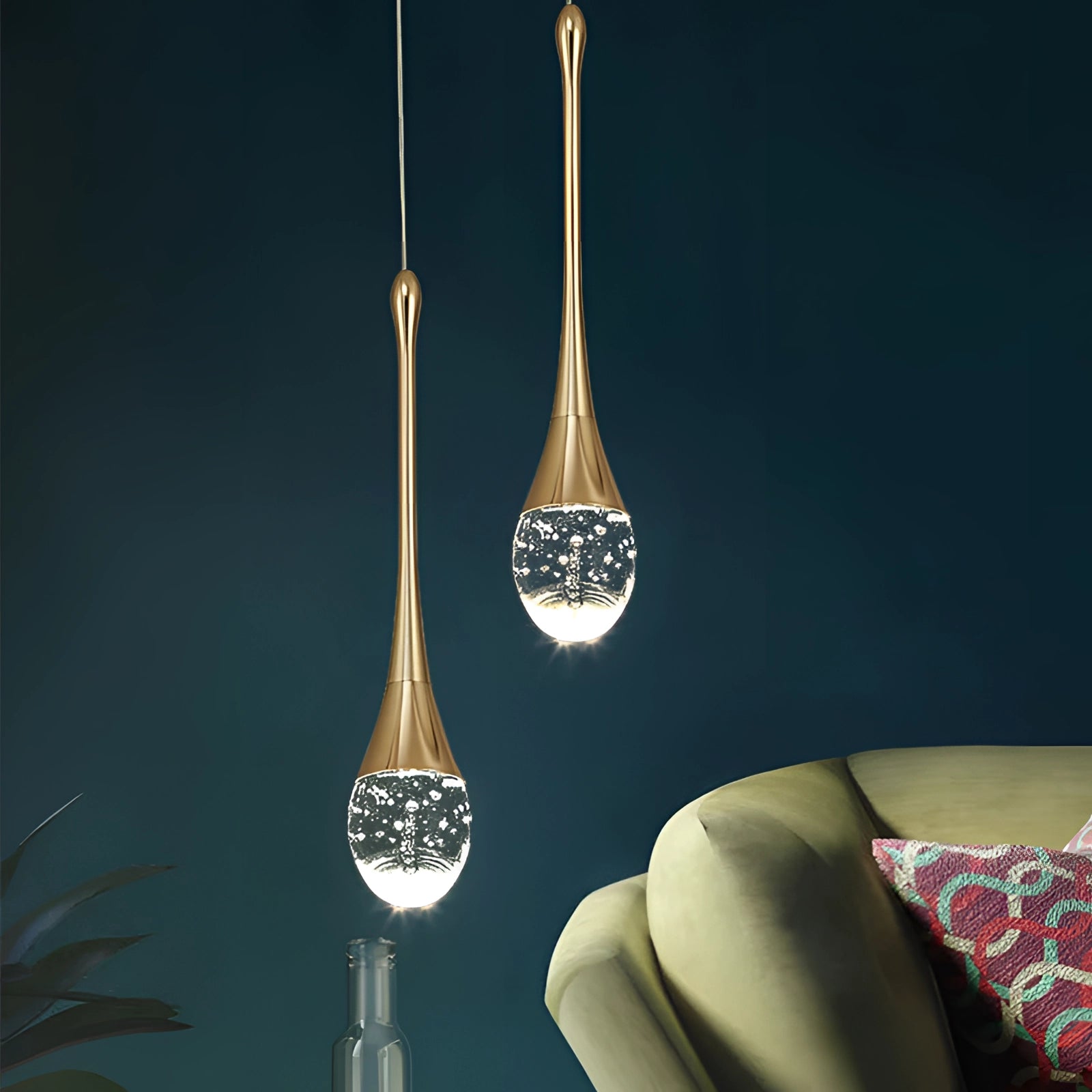 Modern LED gold teardrop pendant lights with glass and metal design, suspended from the ceiling, illuminating a kitchen or dining room setting.