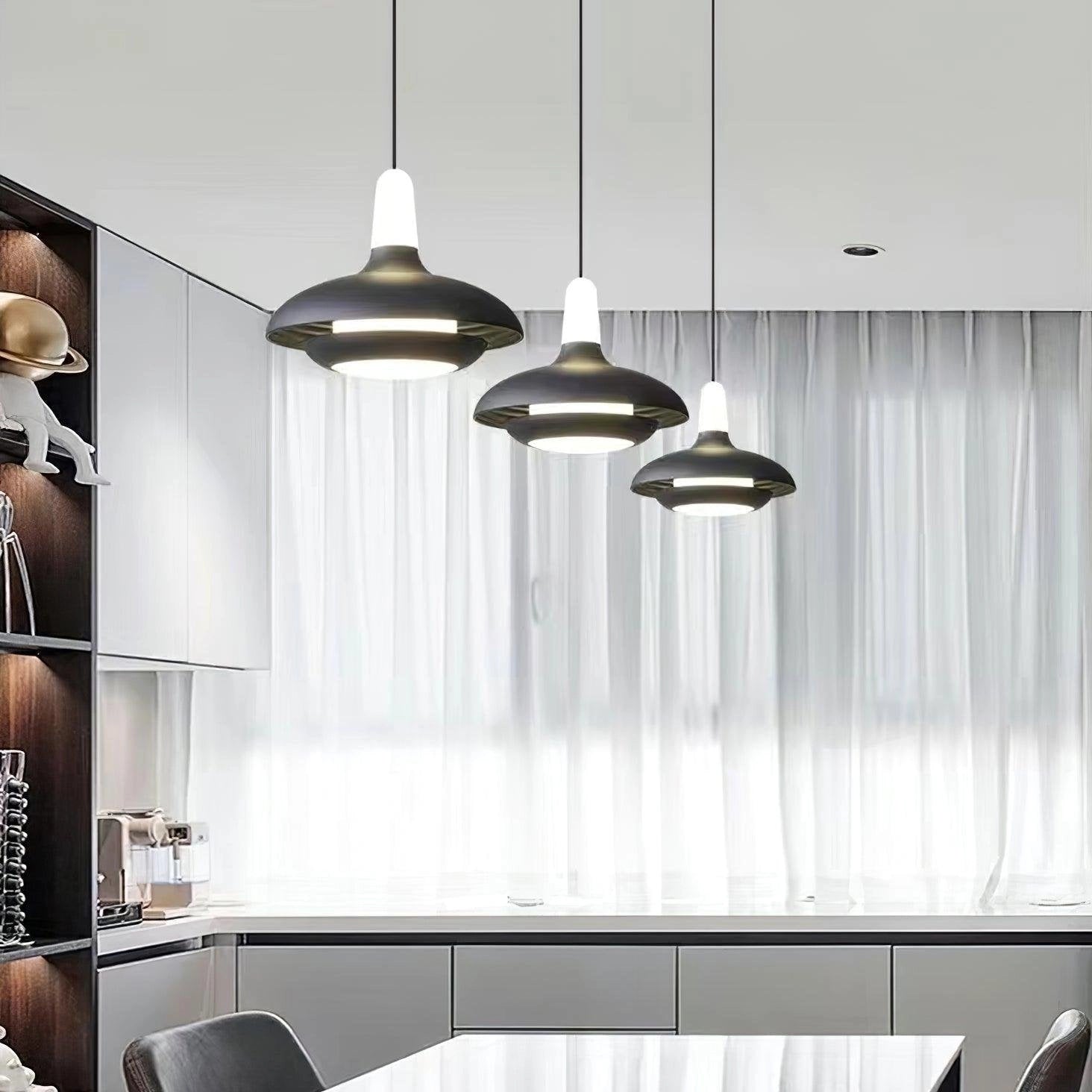 Modern LED pendant light with a sleek and minimalistic design, featuring an adjustable cord. The lamp is suspended from the ceiling, providing contemporary illumination that complements interior design aesthetics. The shade of the light is simple yet elegant, emphasizing clean lines.