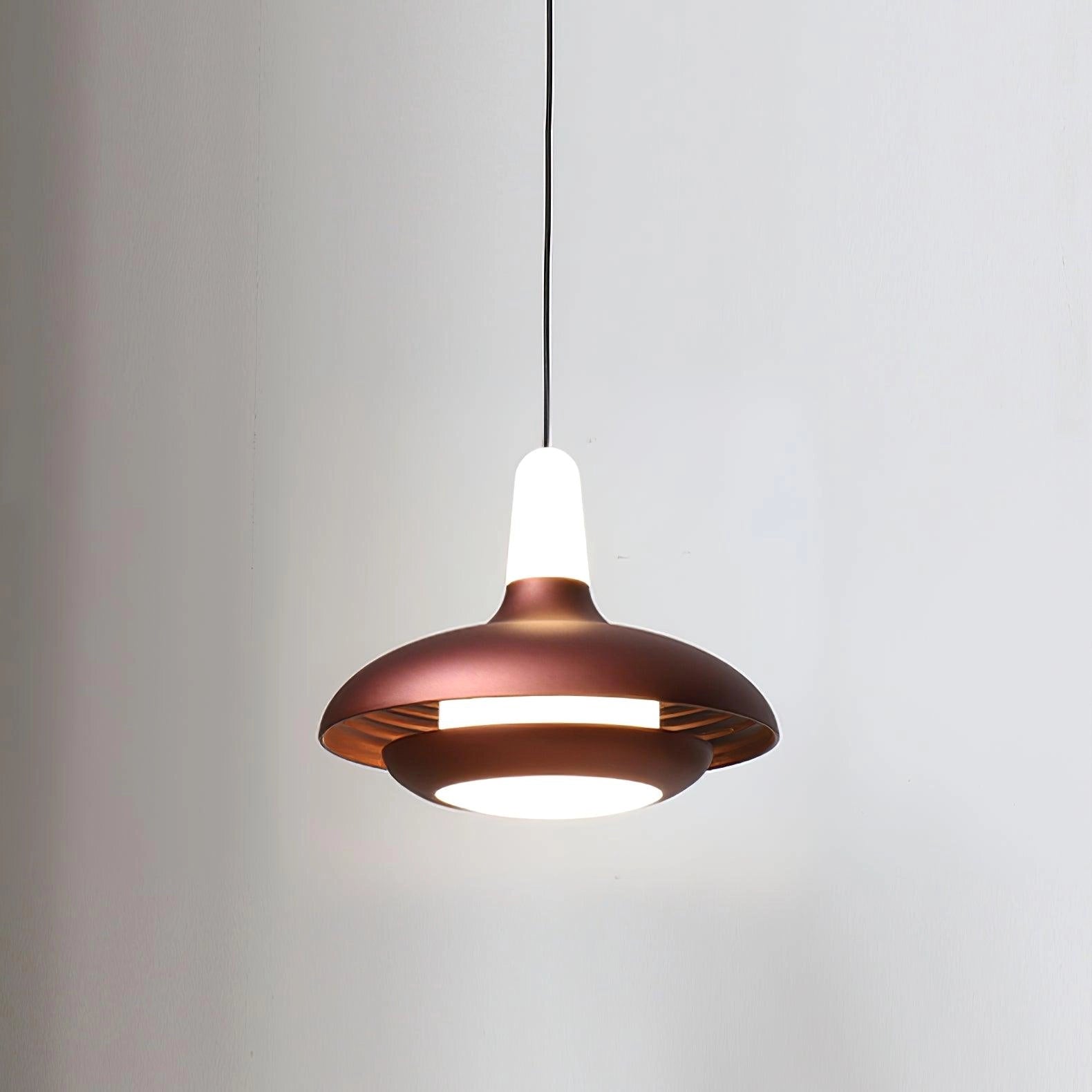 Modern LED pendant light with a sleek, minimalistic design in a Braun finish, featuring an adjustable cord and circular metal ceiling fixture, emitting a warm glow.