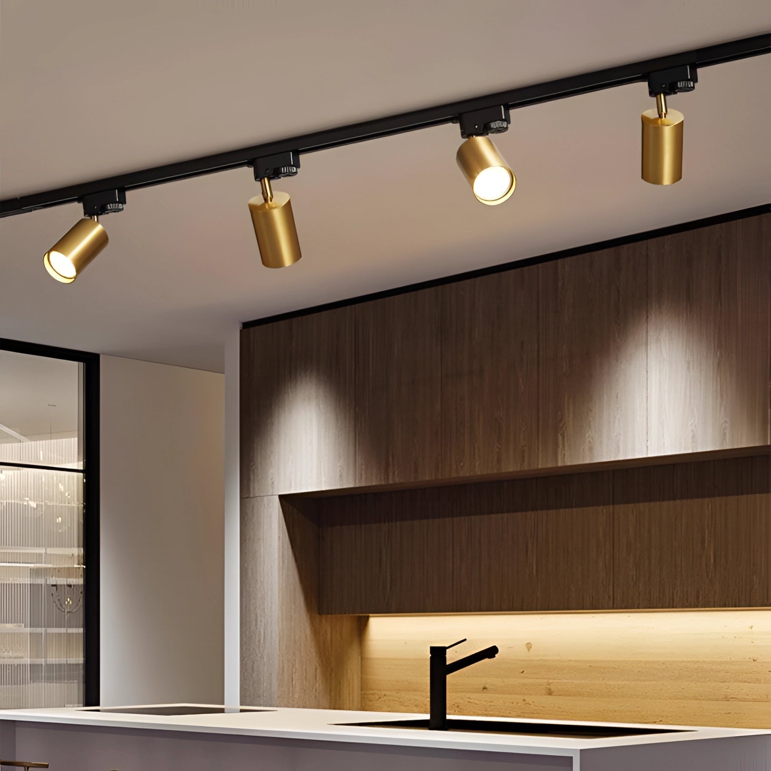 Modern gold LED track lighting fixture with four adjustable ceiling spotlights installed on a ceiling, featuring sleek and contemporary design elements.