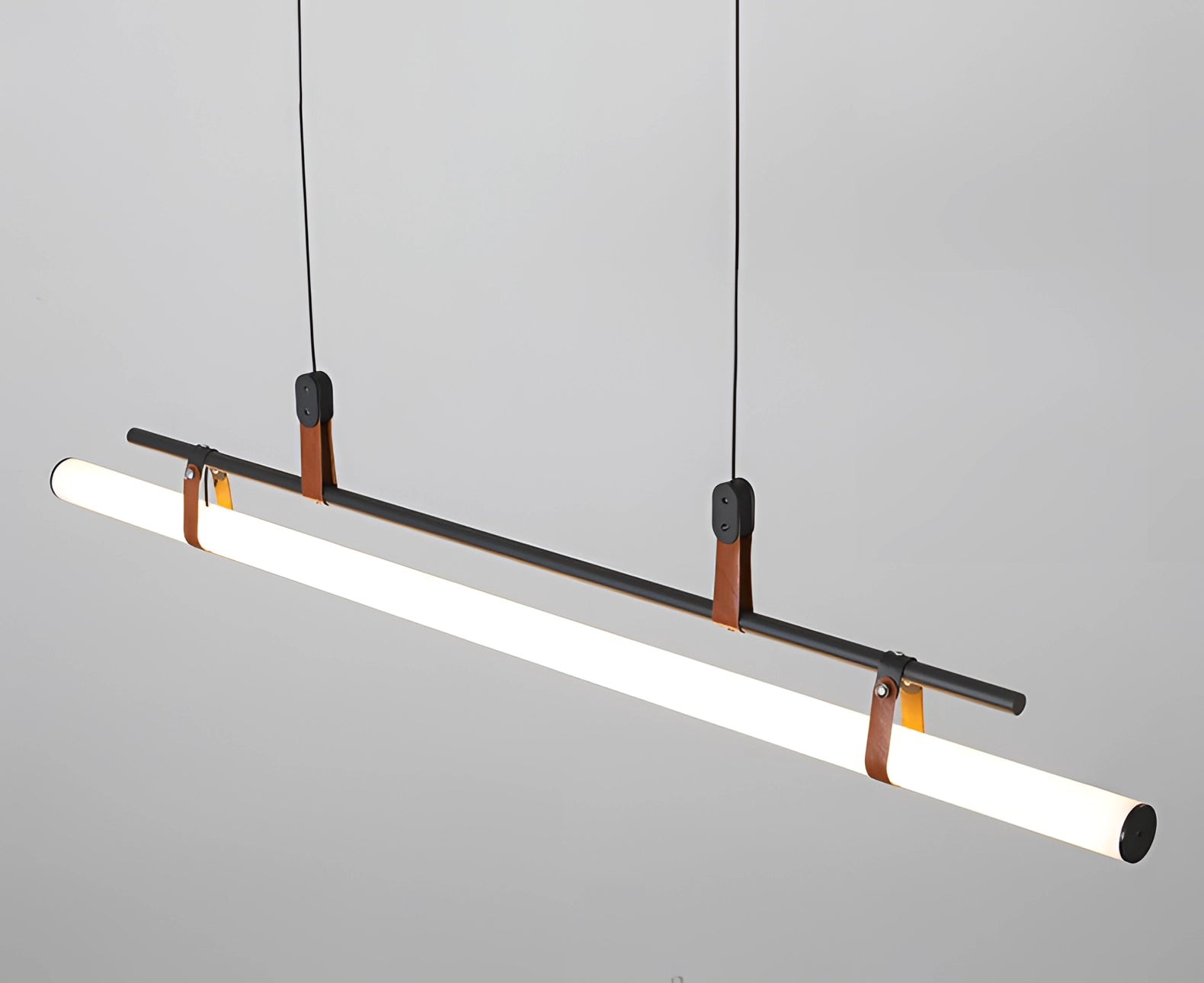 Modern LED tube pendant light with a minimalist design, featuring sleek metal construction and a rectangular shape, ideal for illuminating kitchen and dining room spaces with its contemporary style and symmetrical alignment.