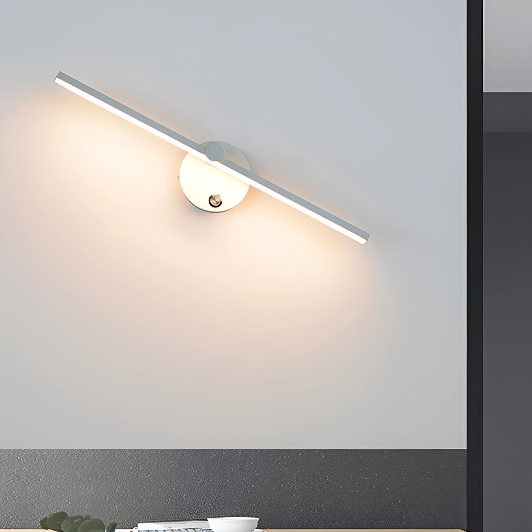 Modern LED wall sconce in brushed gold finish, featuring a white switch and neutral light (4000K), suitable for 220 V-240 V power systems, mounted on a wooden wall surface.