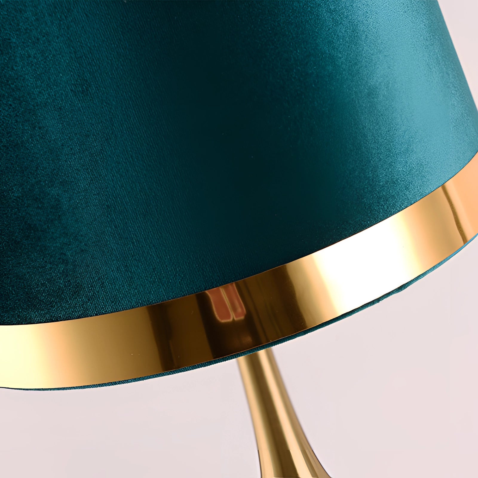 Modern luxury table lamp with a teal velvet shade, featuring a gold base and a marble accent.