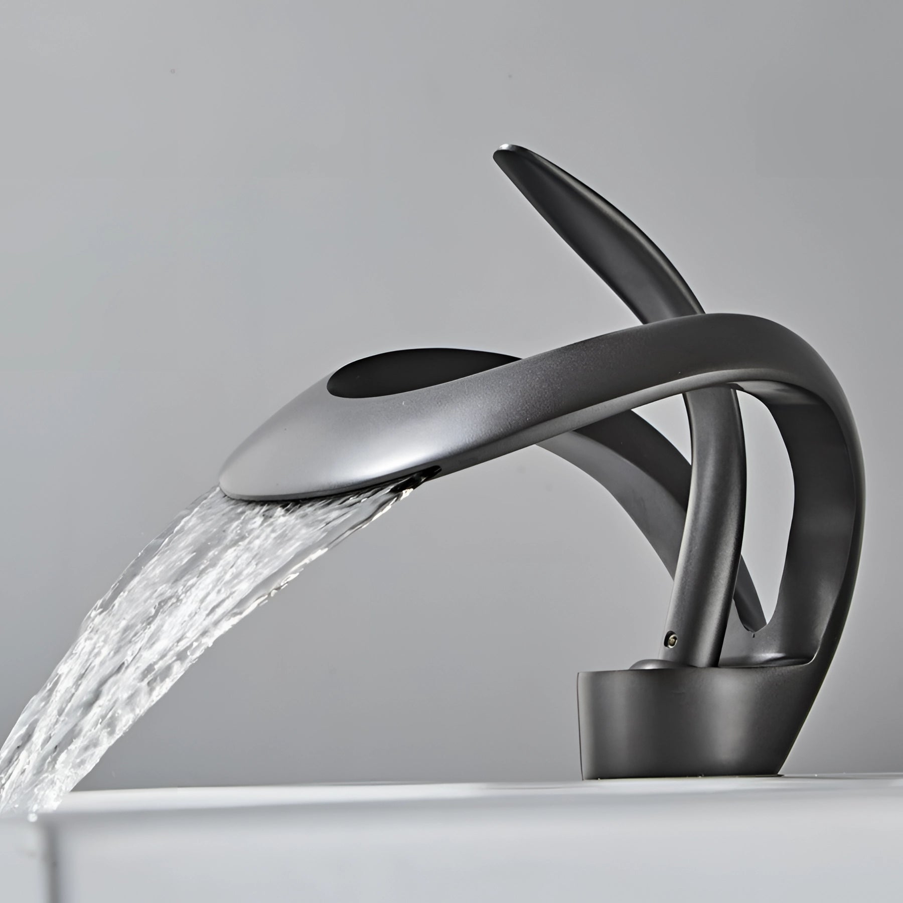 Modern matte black waterfall faucet with sleek, futuristic design, featuring a smooth flow of water reminiscent of a waterfall, made from high-quality metal, suitable for luxury bathroom settings.