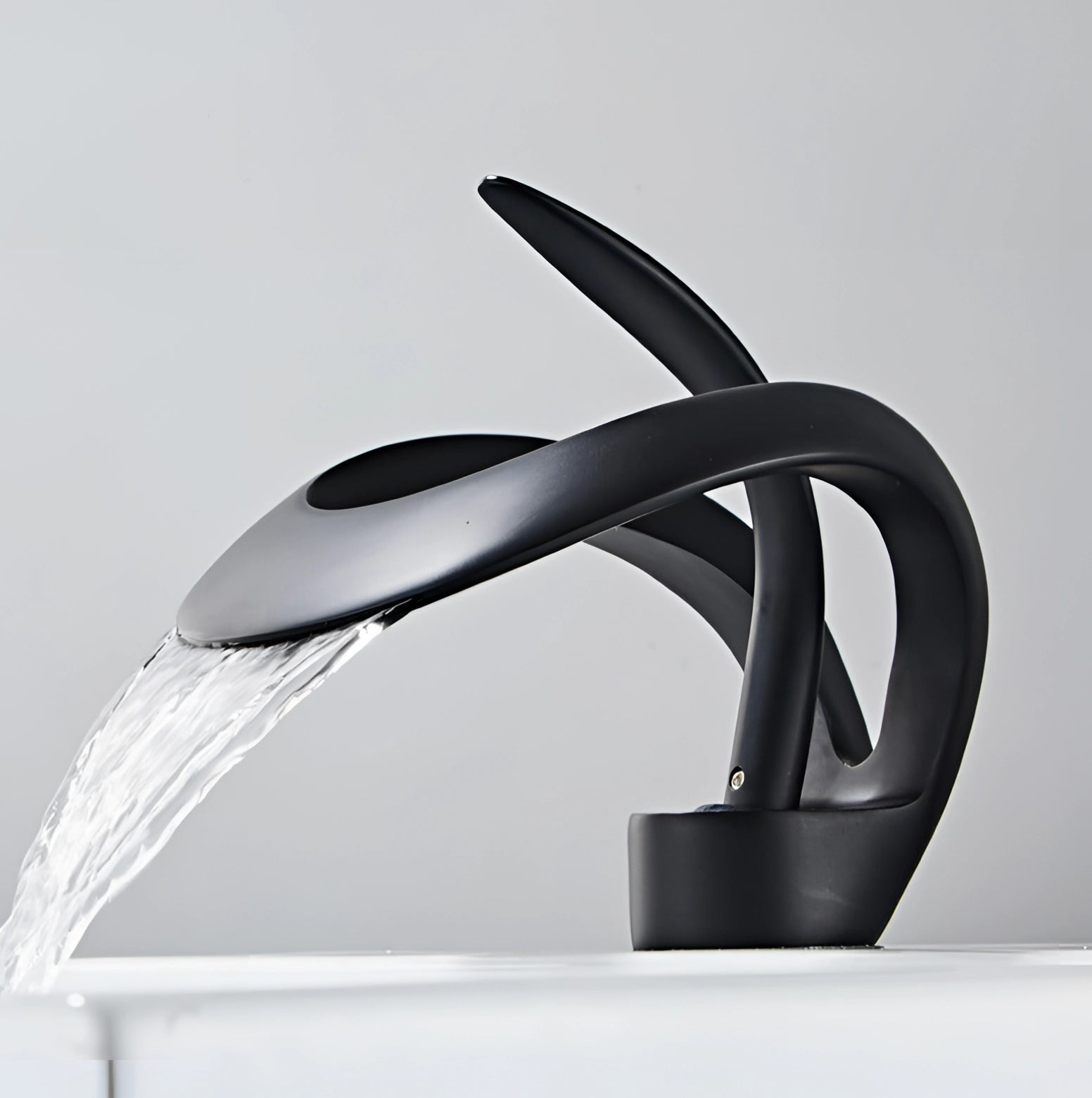 Modern matte black waterfall faucet with a sleek, futuristic design, showcasing a luxurious and sophisticated aesthetic suitable for contemporary bathroom interiors.