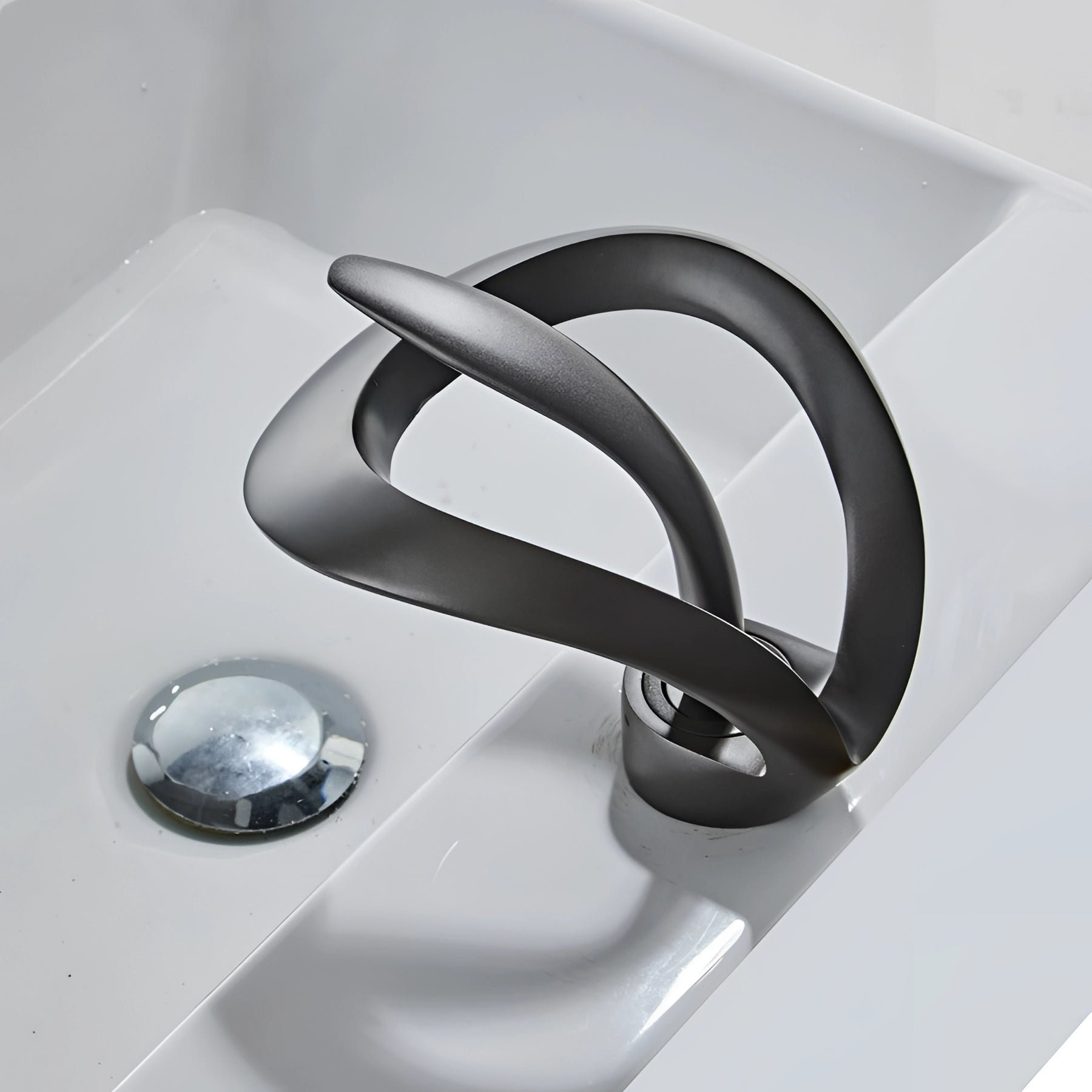 Modern matte black waterfall faucet with sleek, futuristic design suitable for luxury bathroom settings.