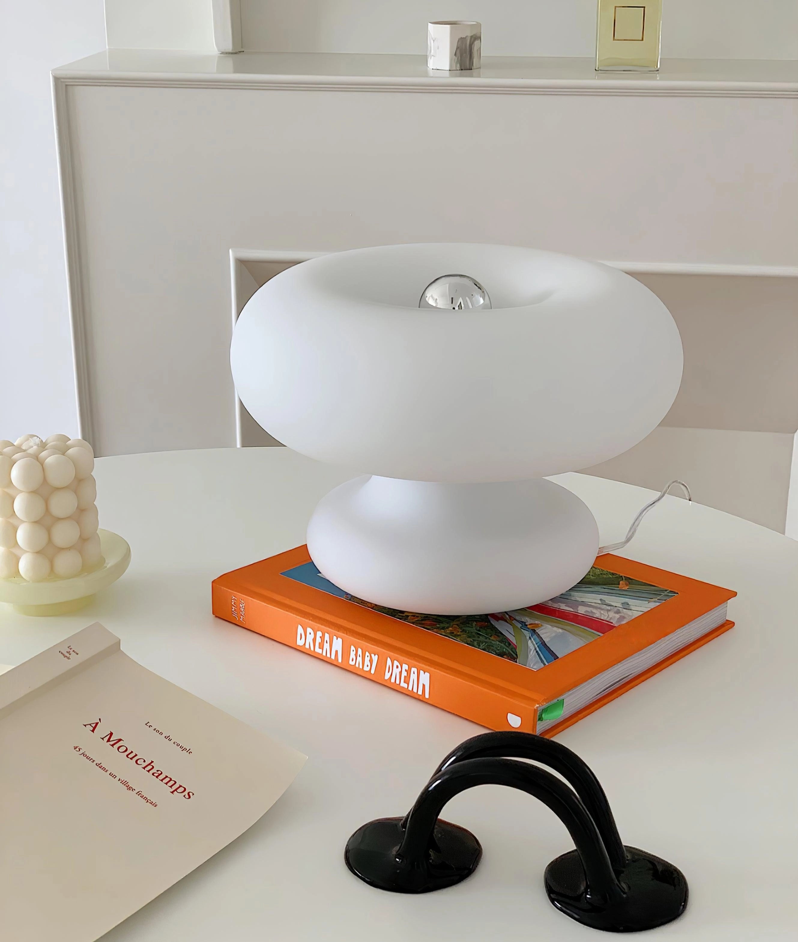 Minimalist modern mushroom table lamp with a sleek design, displayed on a stylish bedside table.