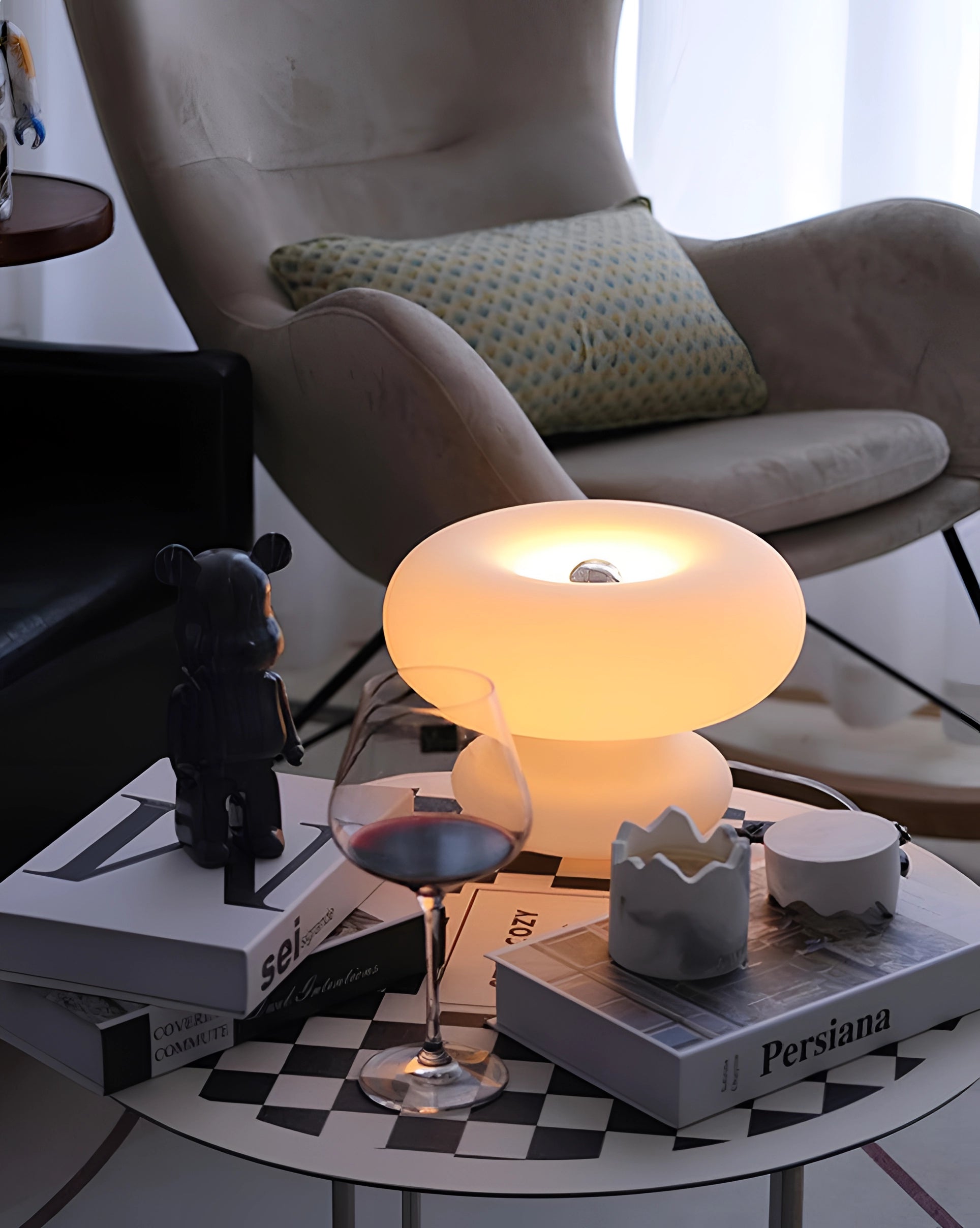 Modern mushroom table lamp with minimalist design, placed on a bedside table in a stylish interior setting.