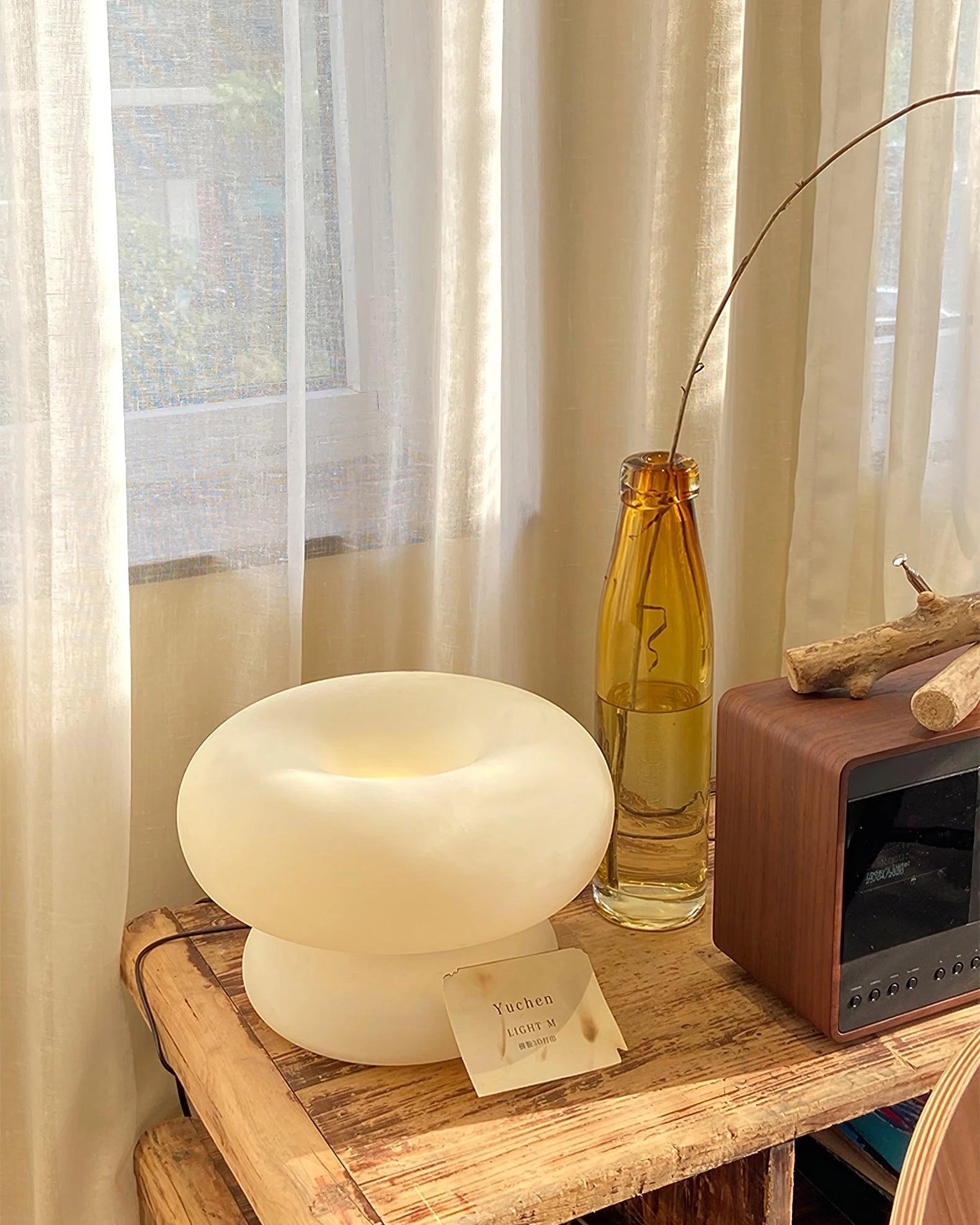 Modern Mushroom Table Lamp with wooden base on a beige shelf in a minimalist interior design setting.