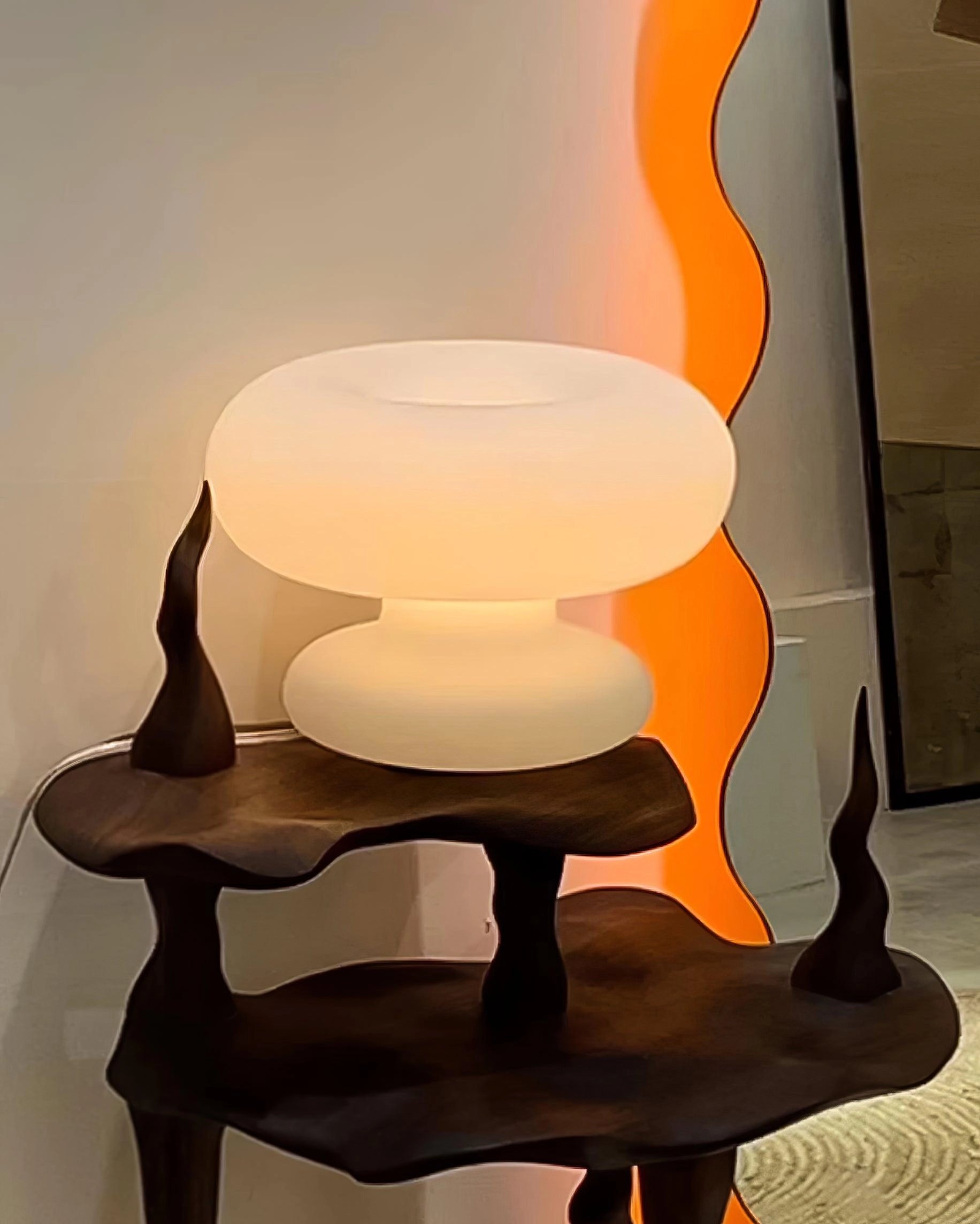 Modern Mushroom Table Lamp with minimalist design, featuring a warm orange and yellow glow, placed on a wooden table.