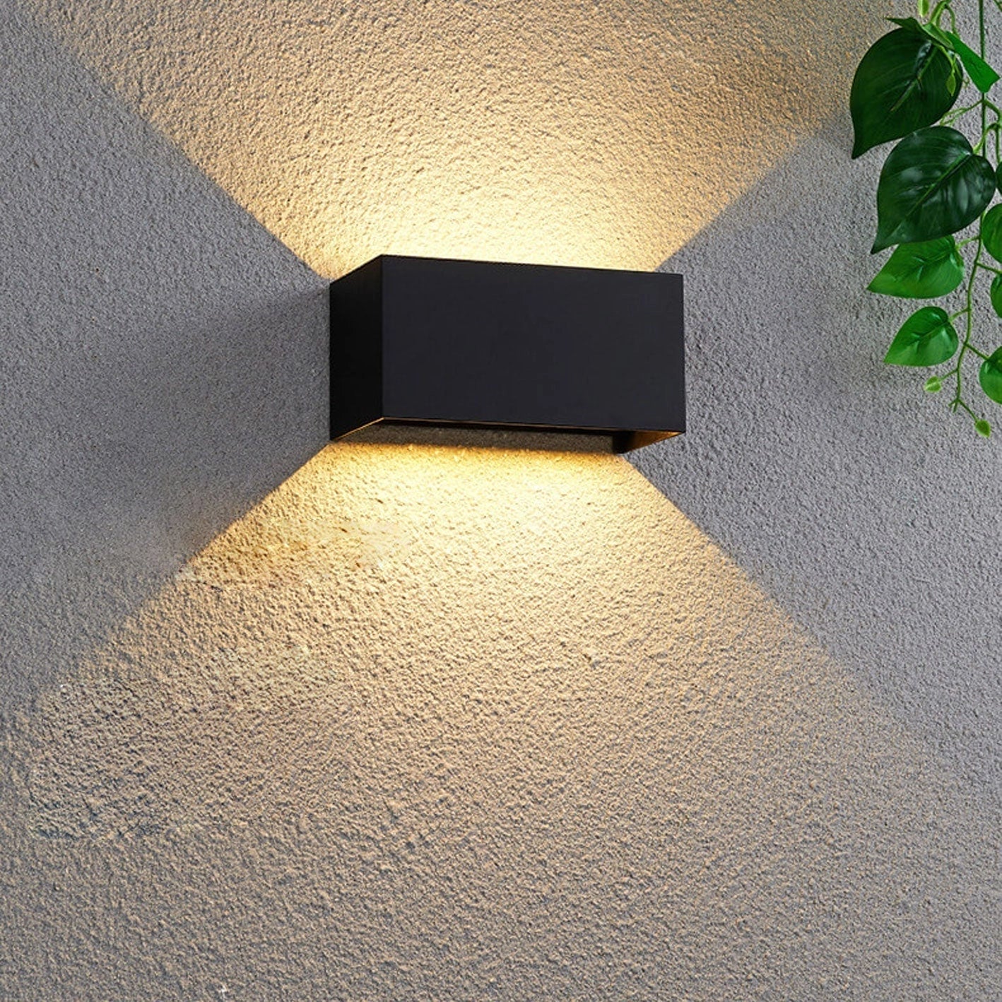 Modern rectangular black LED outdoor wall light mounted on a weather-resistant surface with a symmetrical design.