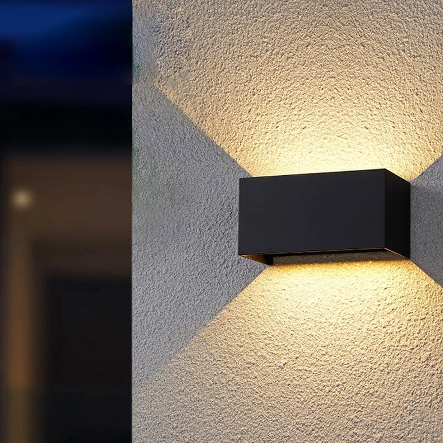 A modern rectangular LED outdoor wall light in black with a sleek design, showcasing a weather-resistant finish. The light emits a white light at 5000K and is suitable for 220V-240V power specifications in Great Britain and Australia. The minimalistic fixture complements contemporary outdoor spaces.