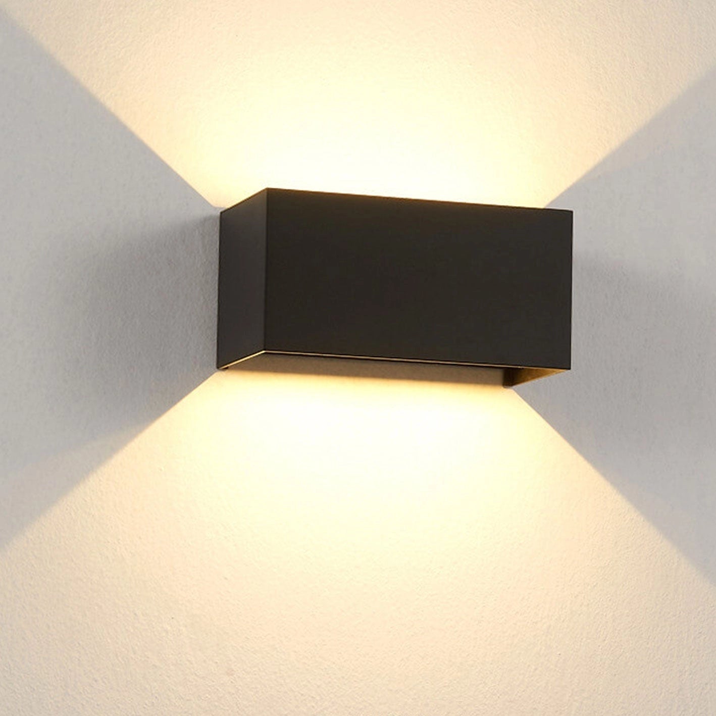 Modern rectangular LED outdoor wall light in black, showcasing a sleek design with a weather-resistant finish. The light emits a white light with a color temperature of 5000K, suitable for 110 V-120 V power systems in the USA/Canada.