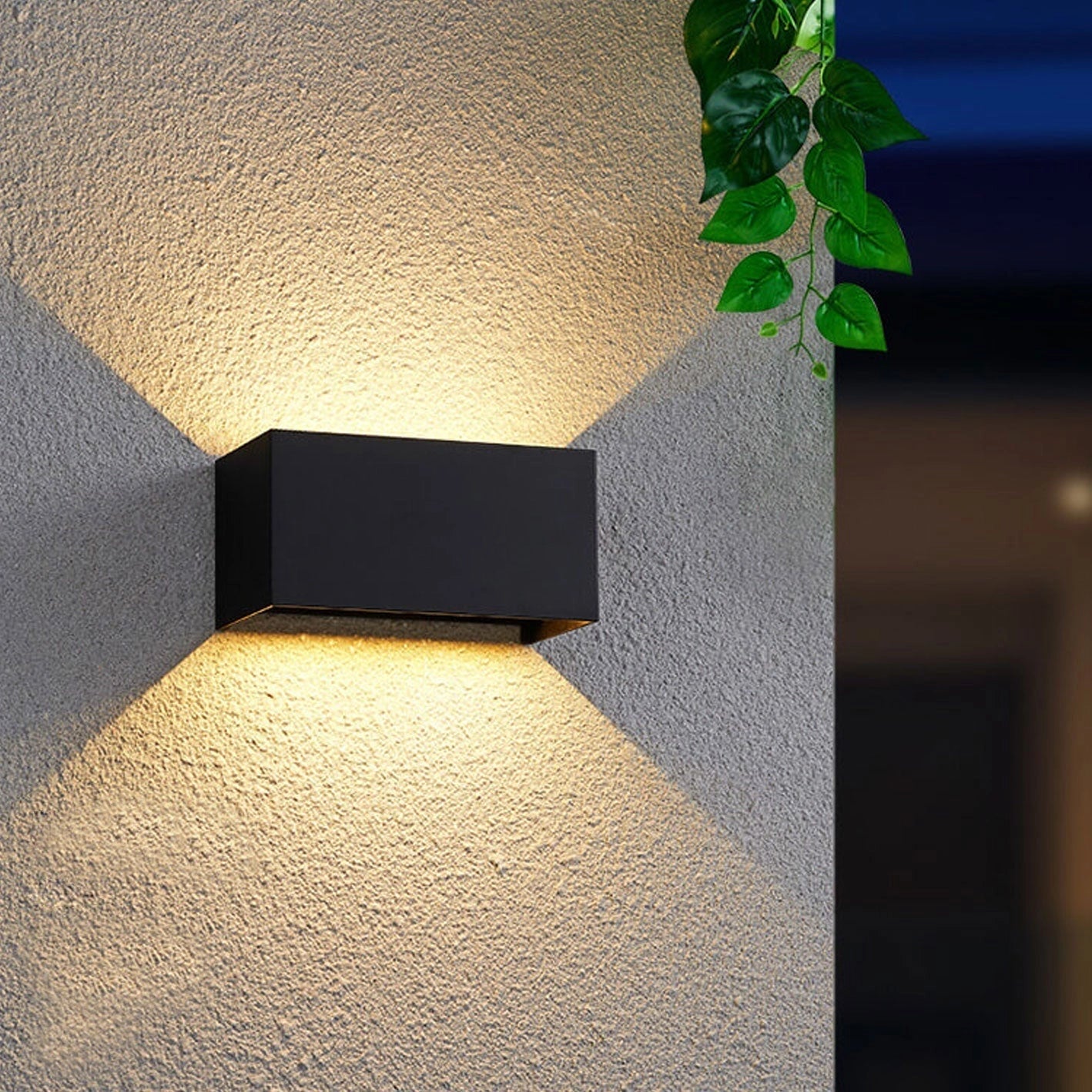 Black modern rectangular LED outdoor wall light mounted on a concrete wall, designed for weather resistance with a warm light output of 3000K, suitable for use in Great Britain and Australia with 24W power and 220 V-240 V voltage compatibility.