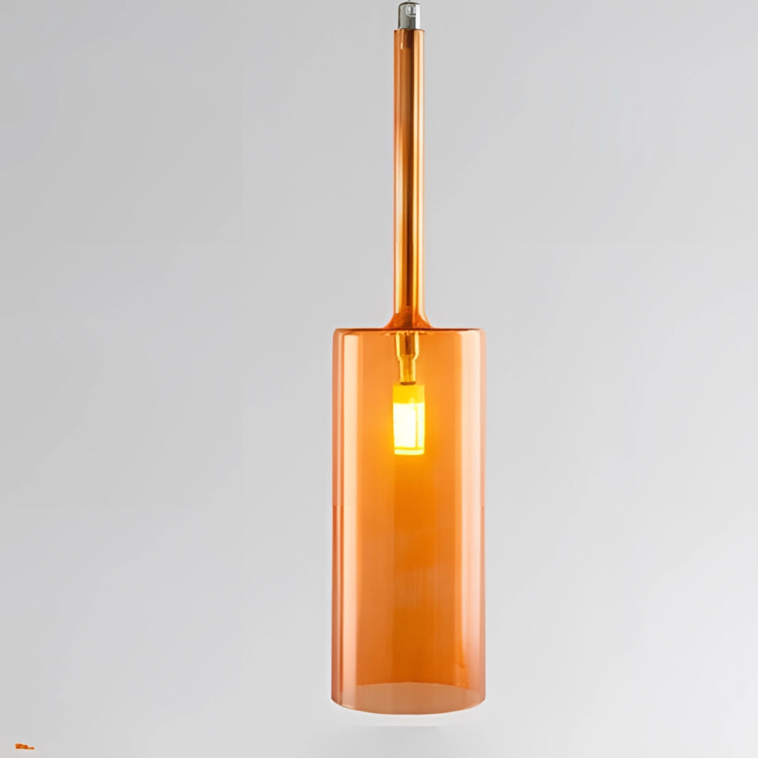 Modern Scandinavian glass pendant light with a sleek, rectangular design in a warm white glow and orange accent, suspended from the ceiling.