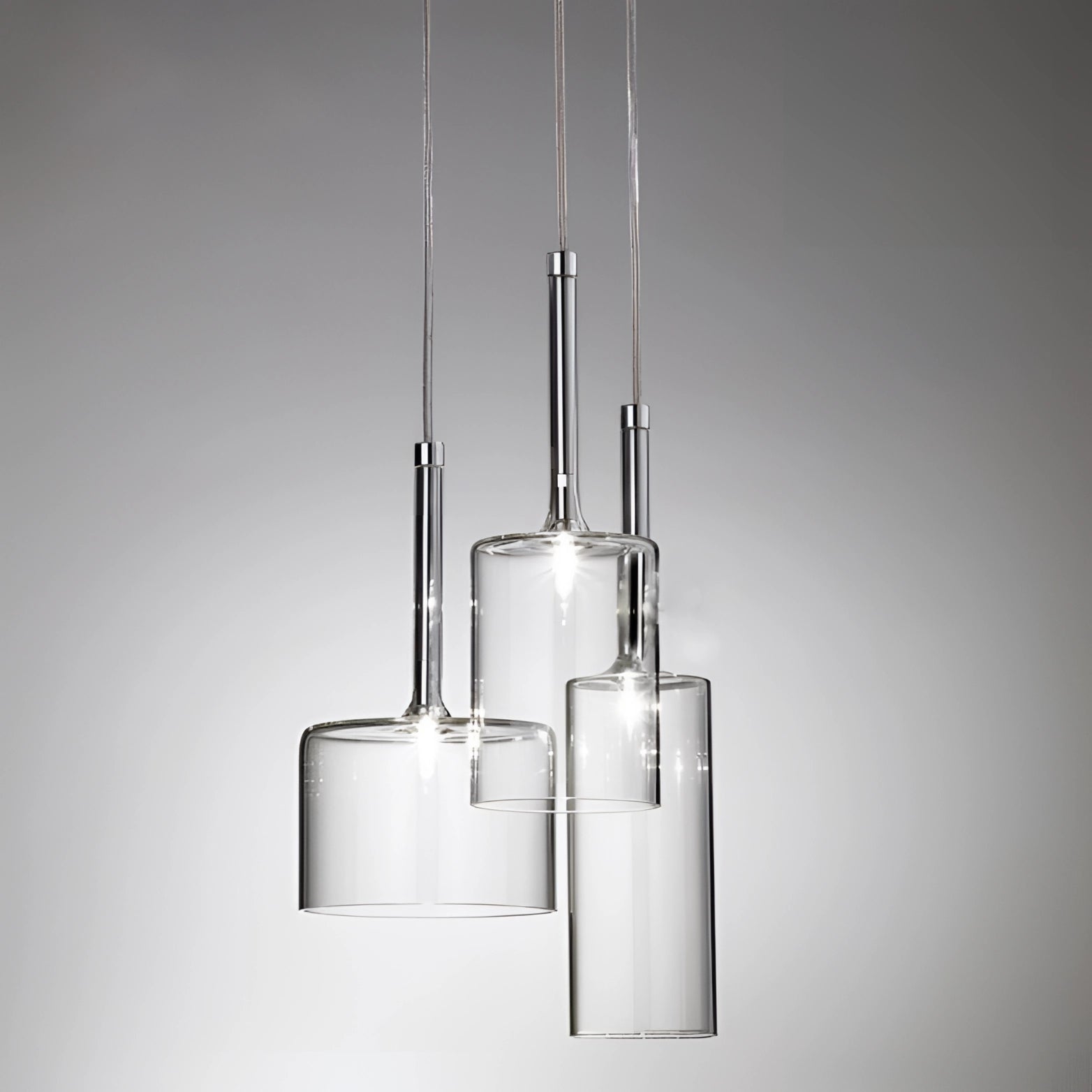 Modern Scandinavian Glass Pendant Light with a sleek, cylindrical design and luxury ceiling fixture featuring metal accents and shaded glass elements.