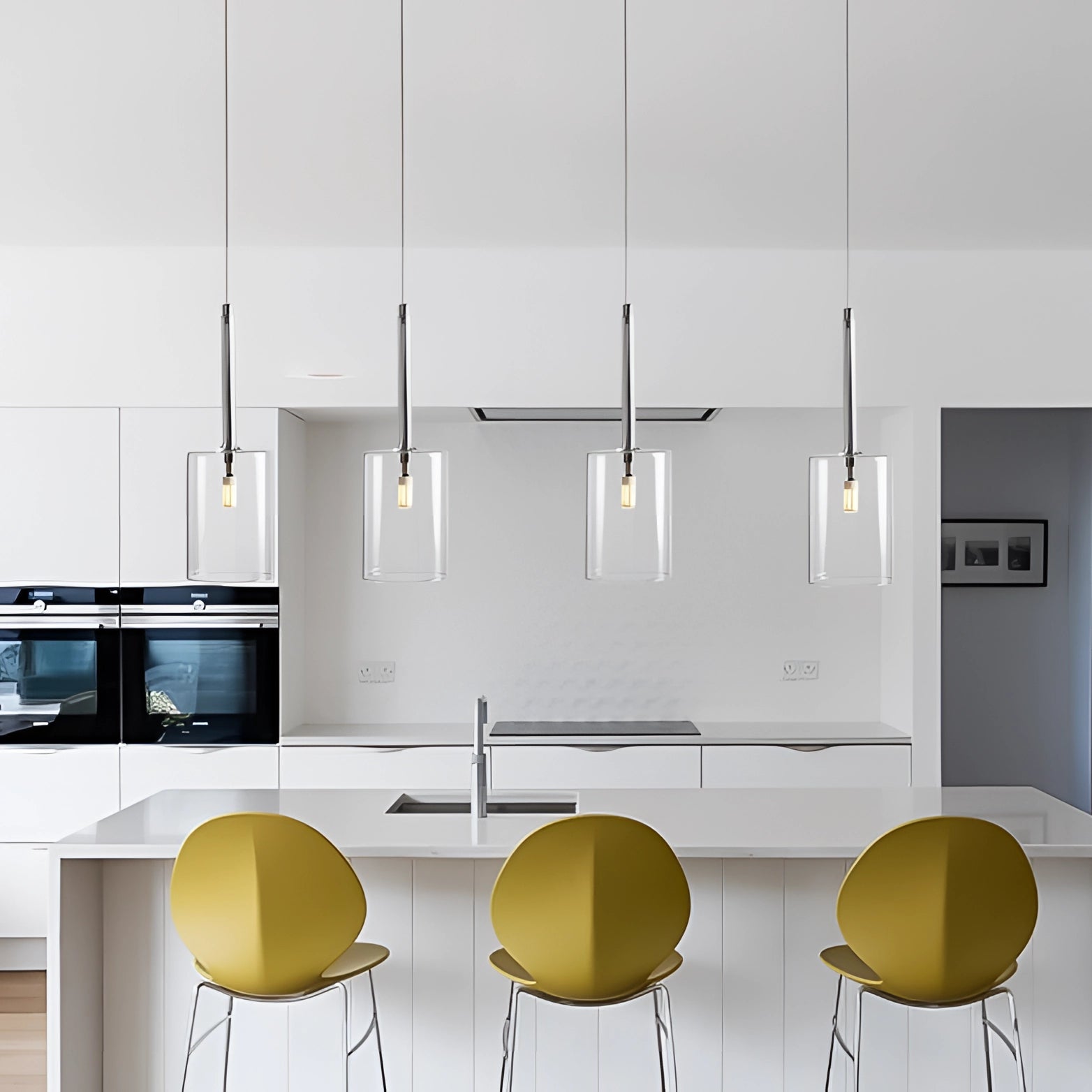 Modern Scandinavian glass pendant lights hanging from the ceiling, featuring minimalistic design elements that enhance the elegant and luxurious appeal of the room's interior decor.