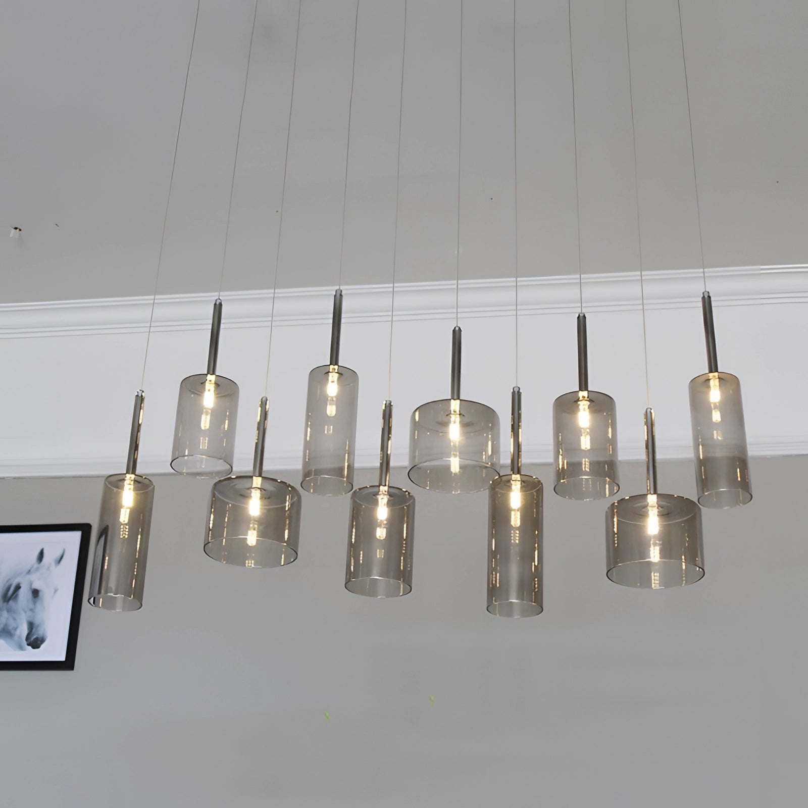 Modern Scandinavian glass pendant light fixture with a sleek design, featuring a single bulb encased in a clear glass shade, suspended from a metal ceiling mount.