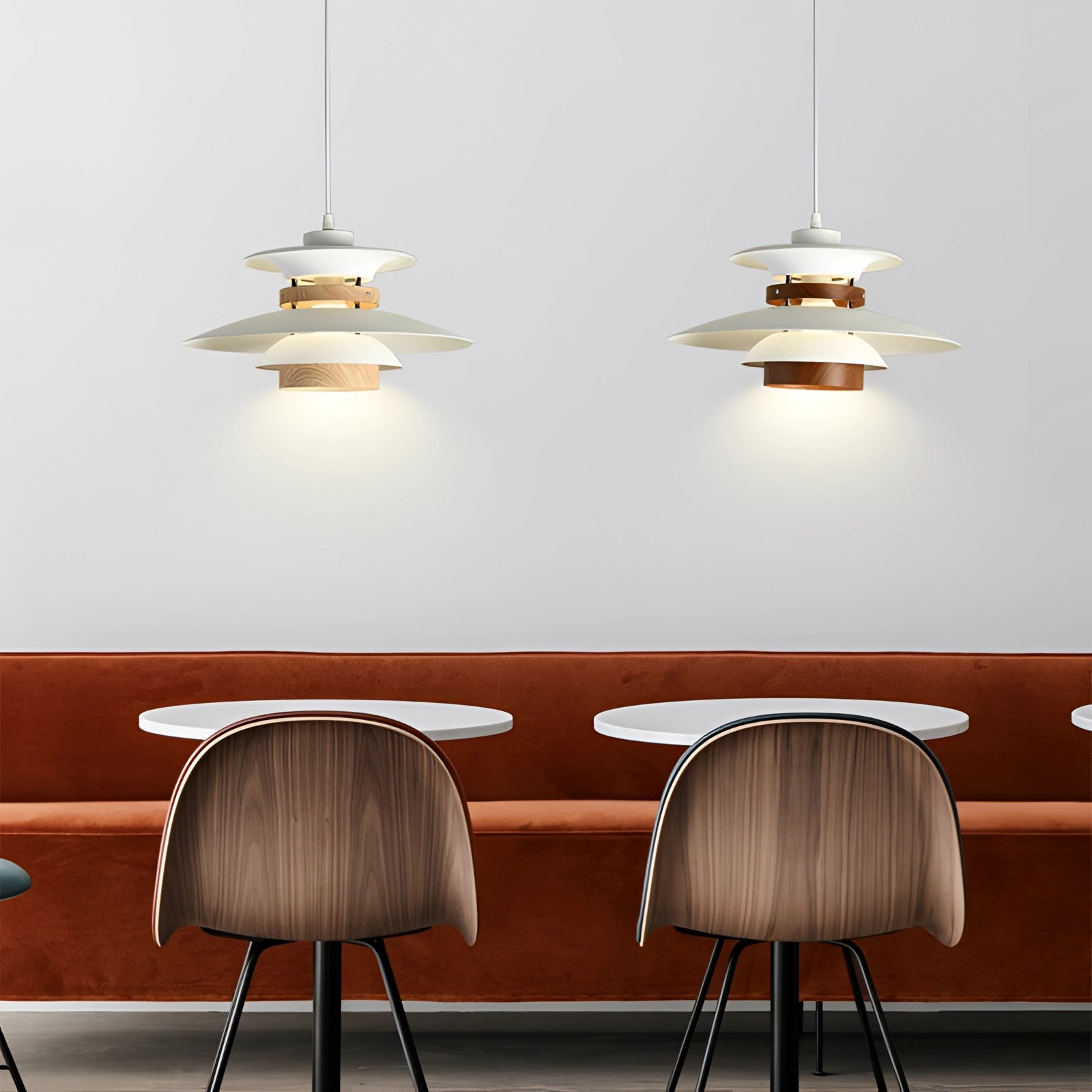 Modern Scandinavian LED pendant light with minimalist wooden design hanging above a wooden table and chairs in a well-lit, white-themed interior.