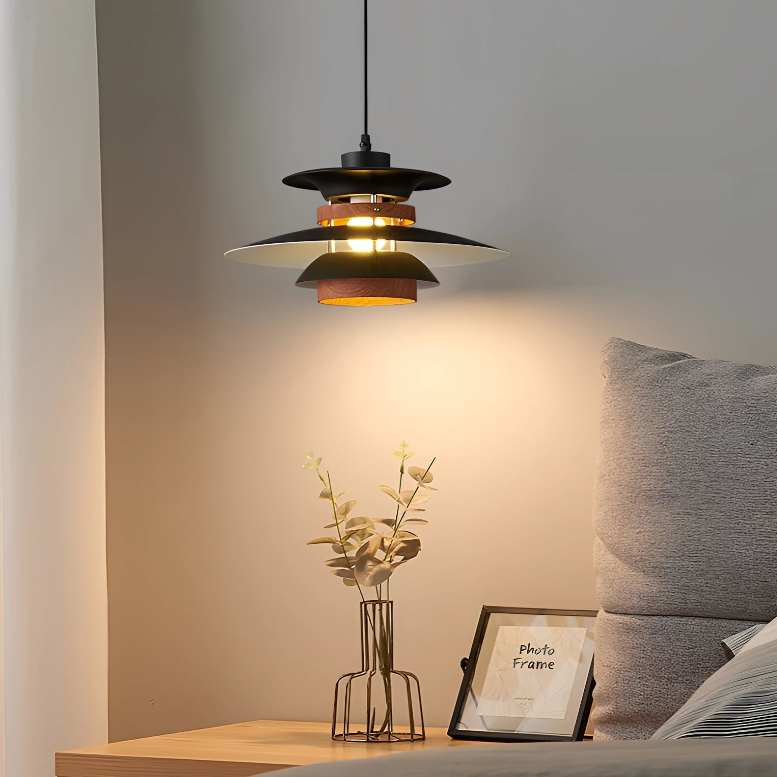 Modern Scandinavian LED pendant light with minimalist wooden design, illuminating a stylish interior with furniture including a table and couch.