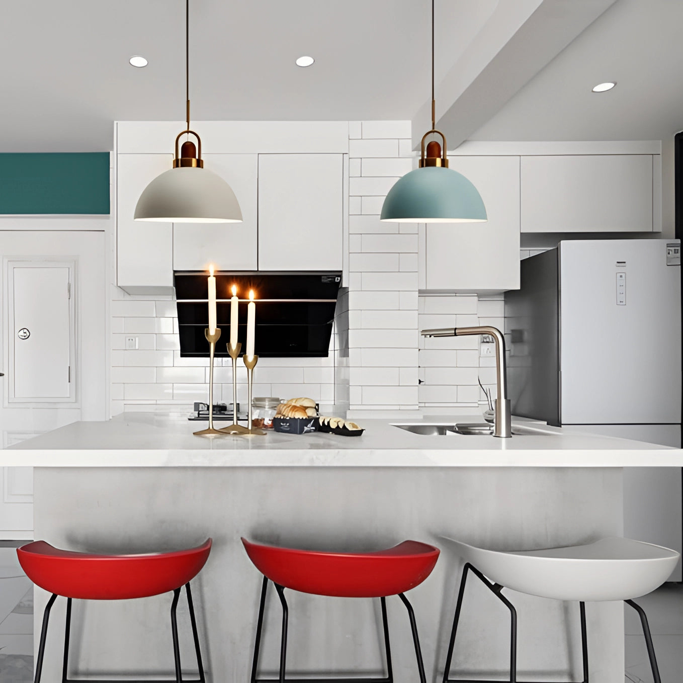 Modern Scandinavian matte pendant lights with copper accents hanging above a sleek kitchen countertop, featuring white cabinetry and shelving.