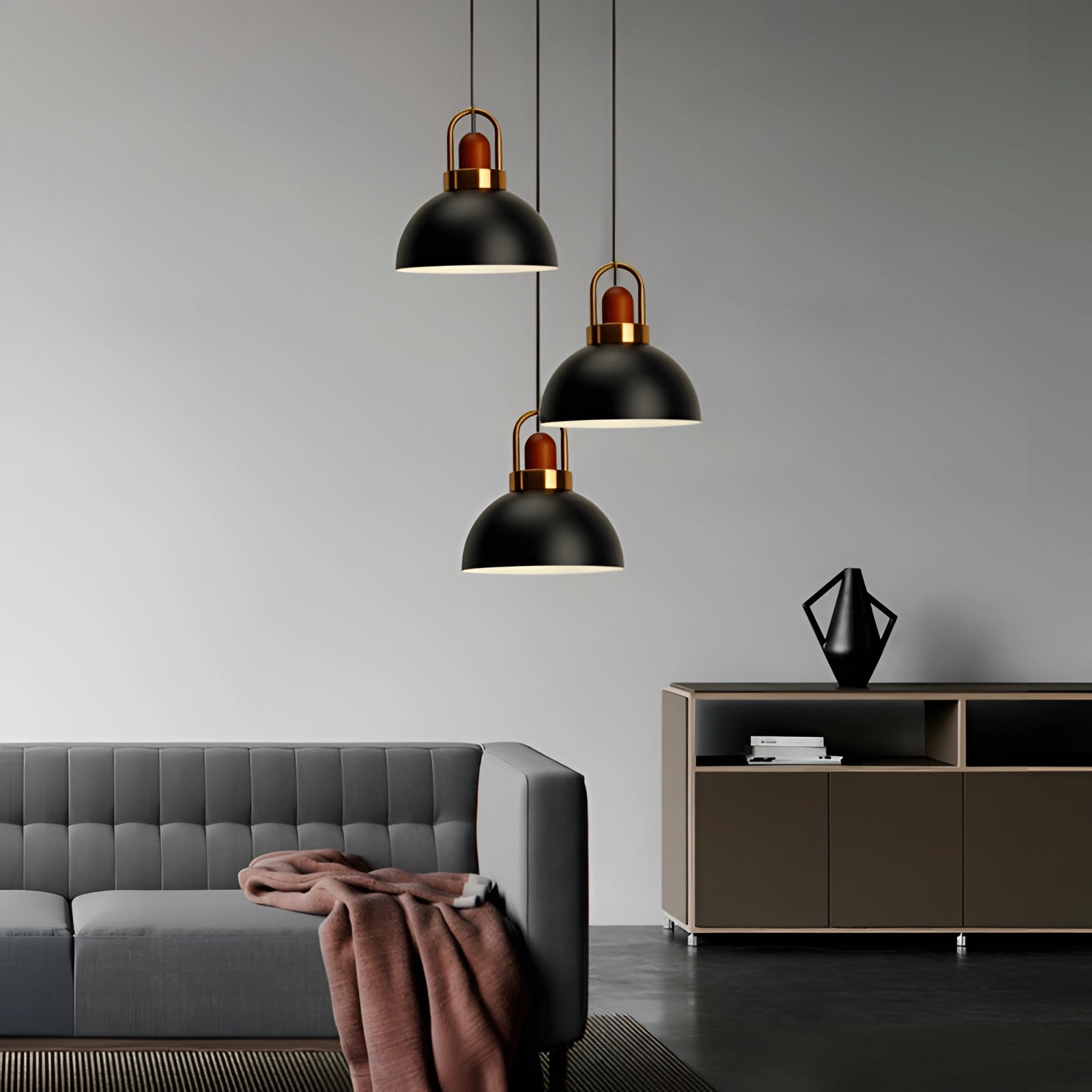 Modern Scandinavian matte pendant lights with copper accents hanging over a sleek interior setup, showcasing a couch and table, enhancing the contemporary design and ambiance of the space.