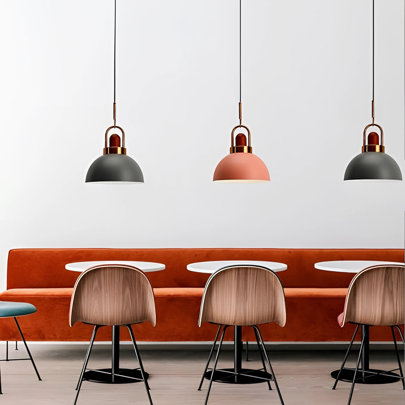 Modern Scandinavian matte pendant lights with a copper accent, featuring a sleek and minimalist design, hanging in a stylish interior setting with white and wood elements.