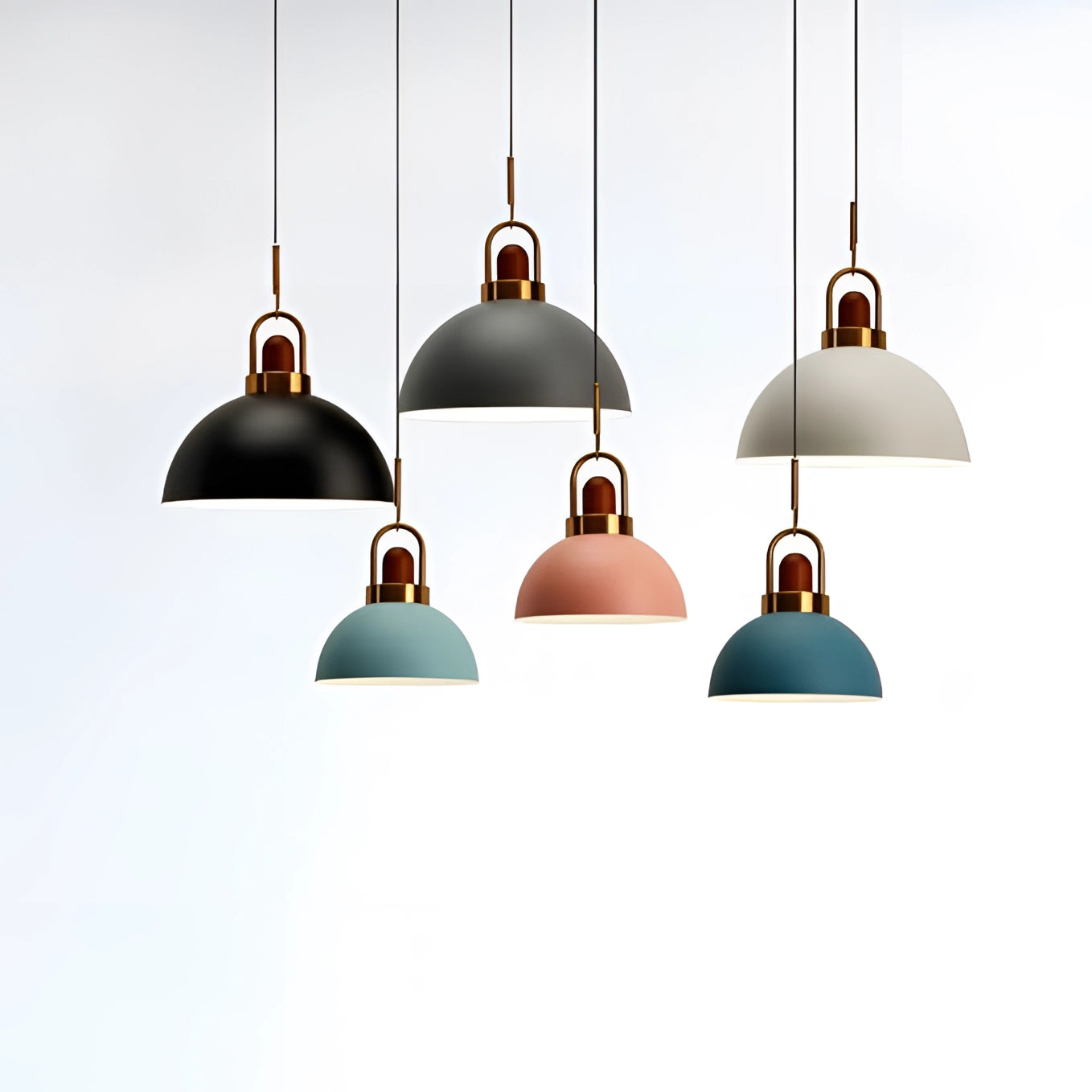 Modern Scandinavian matte pendant lights with a copper accent, featuring a symmetrical dome design, hanging as a ceiling fixture.