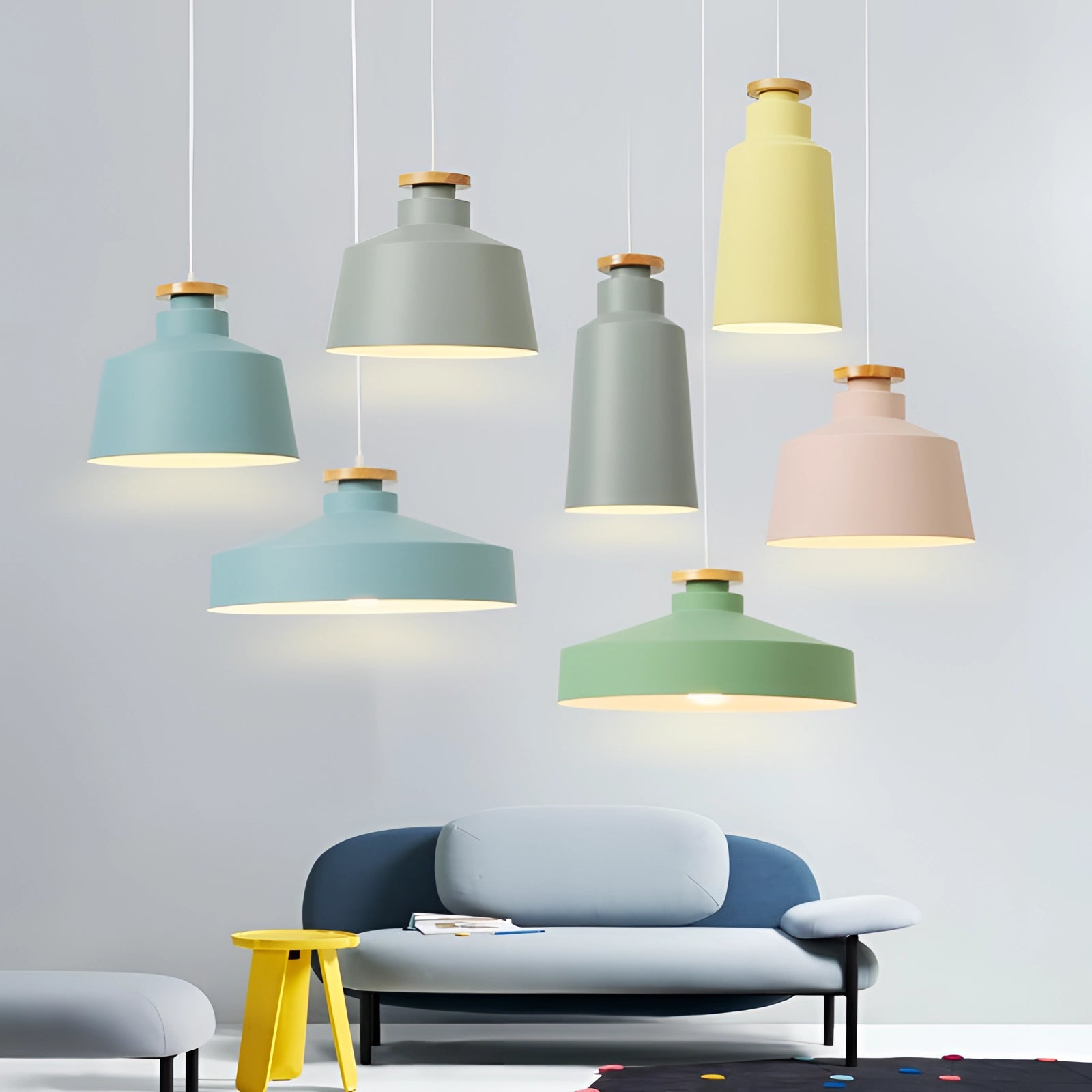 Modern Scandinavian pendant lights in various colors, adjustable designer fixtures, illuminating a contemporary interior space with white and yellow hues.