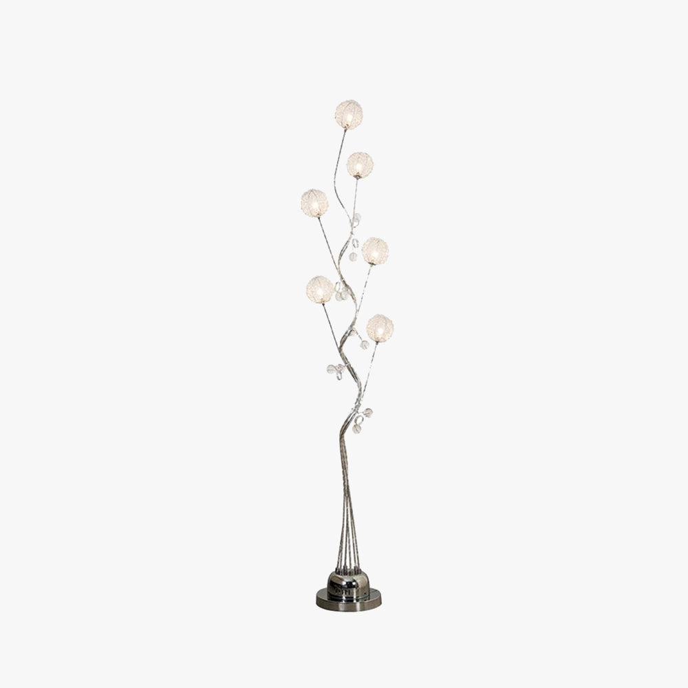 Modern sculptural table lamp designed with a branch-like structure, featuring artistic details and a glass shade, suitable for home decor lighting.