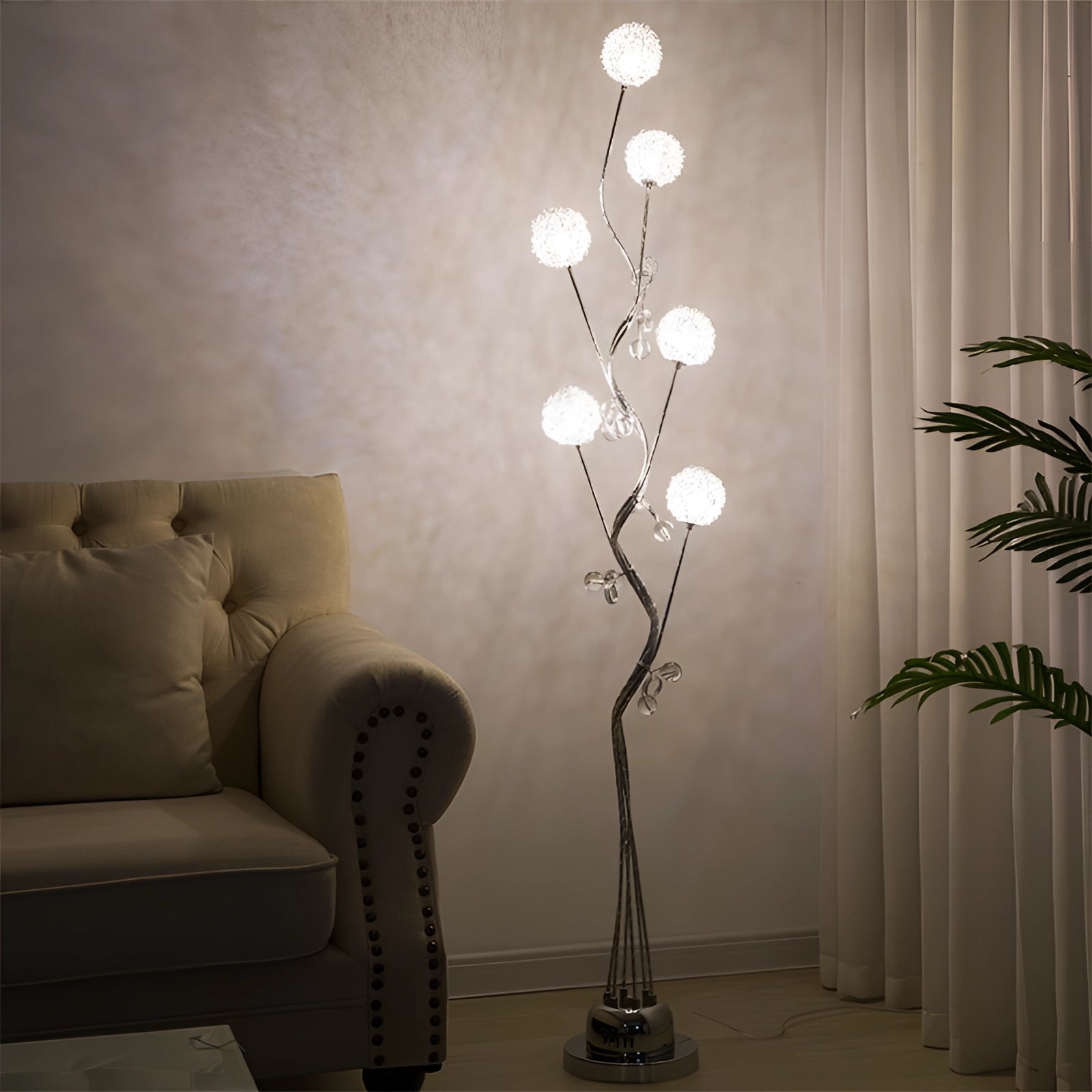 Modern sculptural branch table lamp in a contemporary interior setting, featuring a wooden branch-like design, grey tones, and standing 66 inches tall near a couch.