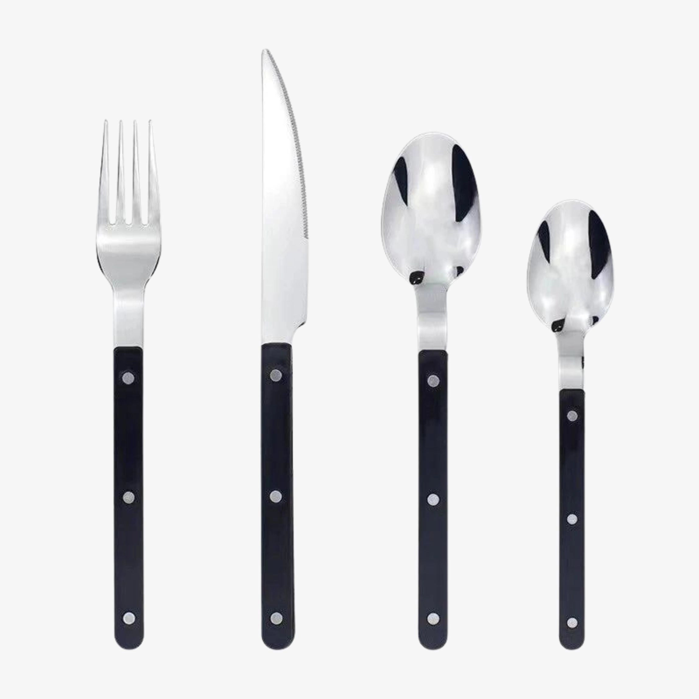 Modern stainless steel cutlery set with black handles, featuring 24 pieces of flatware including forks, knives, and spoons, displayed on a tabletop.