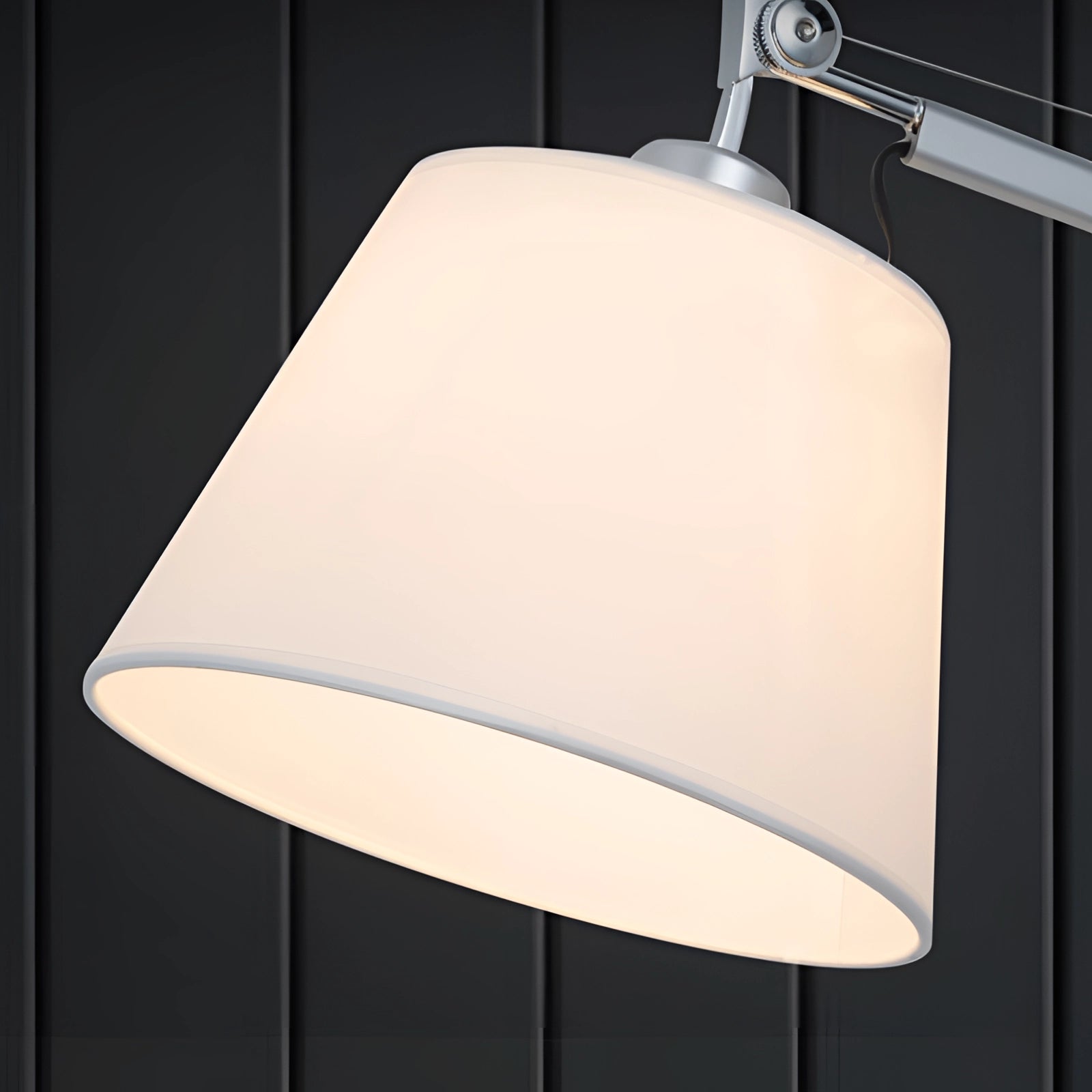 Modern swing arm wall-mounted lamp with adjustable lighting and a rectangular shade, featuring a sleek metal design and contemporary aesthetic.