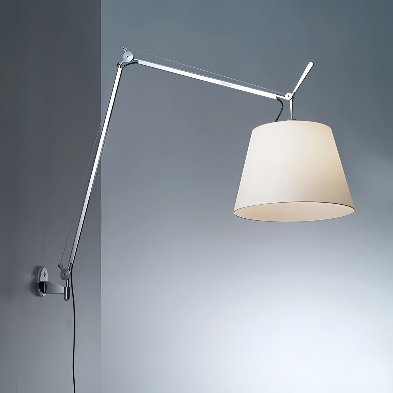 Modern swing arm wall-mounted lamp with shade, featuring adjustable lighting and a metal rectangular fixture.