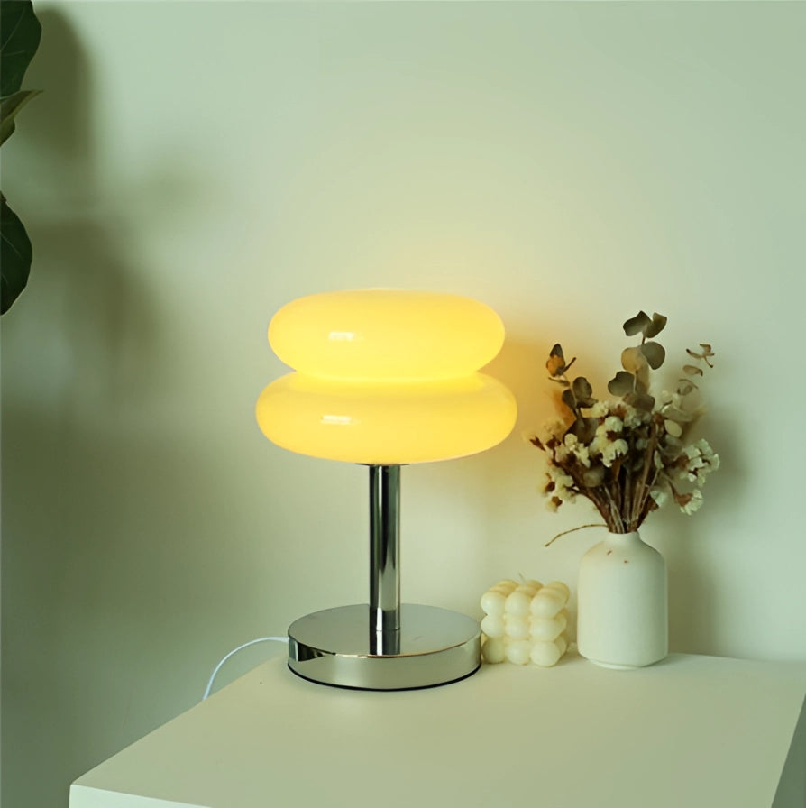 Modern tiered glass table lamp with a beige thick floor base, featuring a minimalist design, a rectangular lampshade, and subtle peach tints, suitable for bedside or living room decor.